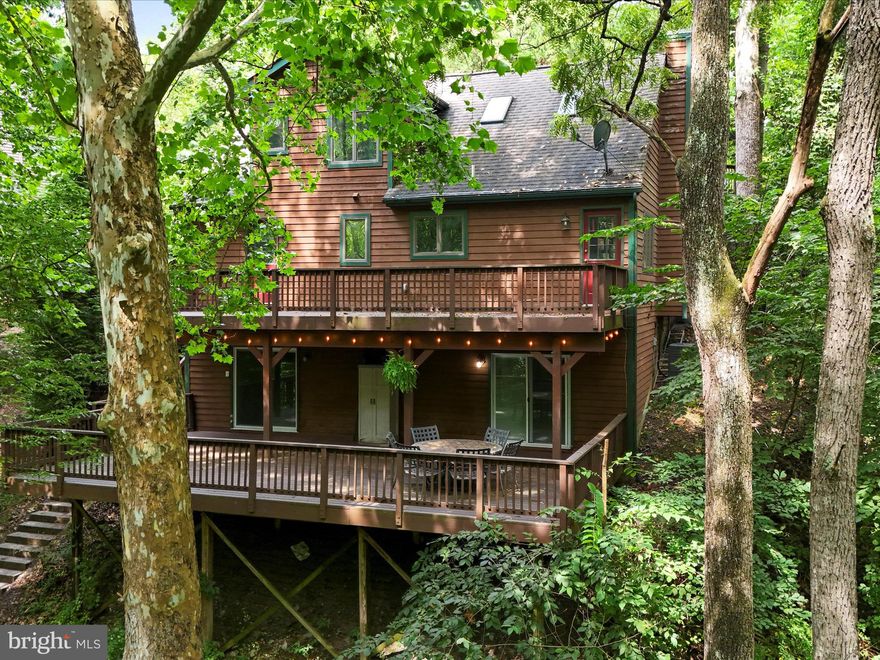 Come tour this stunning mountain-like home nestled in sought-after neighborhood of “The Meadows” in Lake Linganore. 
This home has 4 bedrooms, 4 full baths (2 existing baths were updated and 2 new lower level baths were added in 2022).  In fact, the seller has made nearly $100k in improvements both inside and out.
In addition to a serene, wooded  environment, this residence boasts multi-level decks and hardscape patios, offering ample outdoor living spaces for large gatherings or enjoy the peaceful ambiance with a wood-burning stove, perfect for cozy evenings in.
Step outside, and you'll find a walking path leading directly to the picturesque Lake Linganore, or enjoy a game of pickle-ball, boating, swimming, tennis, basketball, beach volleyball, kayaking, fishing, canoeing, frisbee golf, food trucks, farmers markets, Summer concert series under the stars, playgrounds and so much more!  
This home is not only beautiful; but also eco-friendly, featuring an electric vehicle hook-up to accommodate your electric vehicle. The upper parking pad allows for at least 3 vehicles.  Whether you're seeking a peaceful retreat or a dynamic community experience, this property delivers on all fronts.

Don’t miss your chance to call this your home TODAY; it won’t last long!
Please follow this link to fill out an application: https://apply.link/VOnhyL4