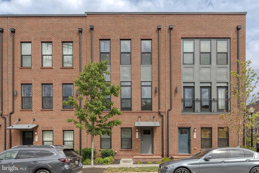 Welcome to your dream home in the heart of Brewers Hill! This beautifully upgraded 4-bedroom, 3.5-bath residence offers 2,476 sq ft of stylish living space, thoughtfully designed for both comfort and entertaining. The entry level features a private bedroom with full bath—ideal for guests or a home office—along with an oversized 2-car garage. Upstairs, the open-concept main level is a showstopper, boasting a gourmet kitchen with an enormous quartz island, stainless steel appliances, large pantry, and custom lighting. A spacious dining and living area is enhanced by elegant accent details, tall ceilings, and seamless access to a private balcony—perfect for morning coffee or evening cocktails. The luxurious primary suite offers a spa-like bath with dual vanities and frameless shower, plus a generous walk-in closet. Two additional bedrooms, a full bath, and laundry complete the sleeping level. The top-floor loft is an entertainer’s paradise, with wet bar, beverage fridge, and access to two expansive rooftop decks showcasing sweeping city views. Enjoy the convenience of being just steps to shops, dining, fitness studios, Canton Waterfront Park, and VOLO Sports, with quick access to I-95, Johns Hopkins, and downtown Baltimore. This is urban living at its finest—modern amenities, unbeatable location, and space to live, work, and play.