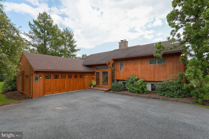 Stunning contemporary raised rancher set on a picturesque one acre lot with lush landscaping and beautiful views.  Spacious kitchen with dining area and island features numerous large windows and skylights, providing lots of natural lighting. The living room with a wood burning fireplace, hardwood flooring, and scenic views from the many windows, offers a serene space for relaxing. Finished basement opens to screened in porch, which overlooks the private back yard. Home has gorgeous wood ceilings throughout, and is great for entertaining with its open concept floor plan, heated in-ground pool and hot tub, patio, and deck.