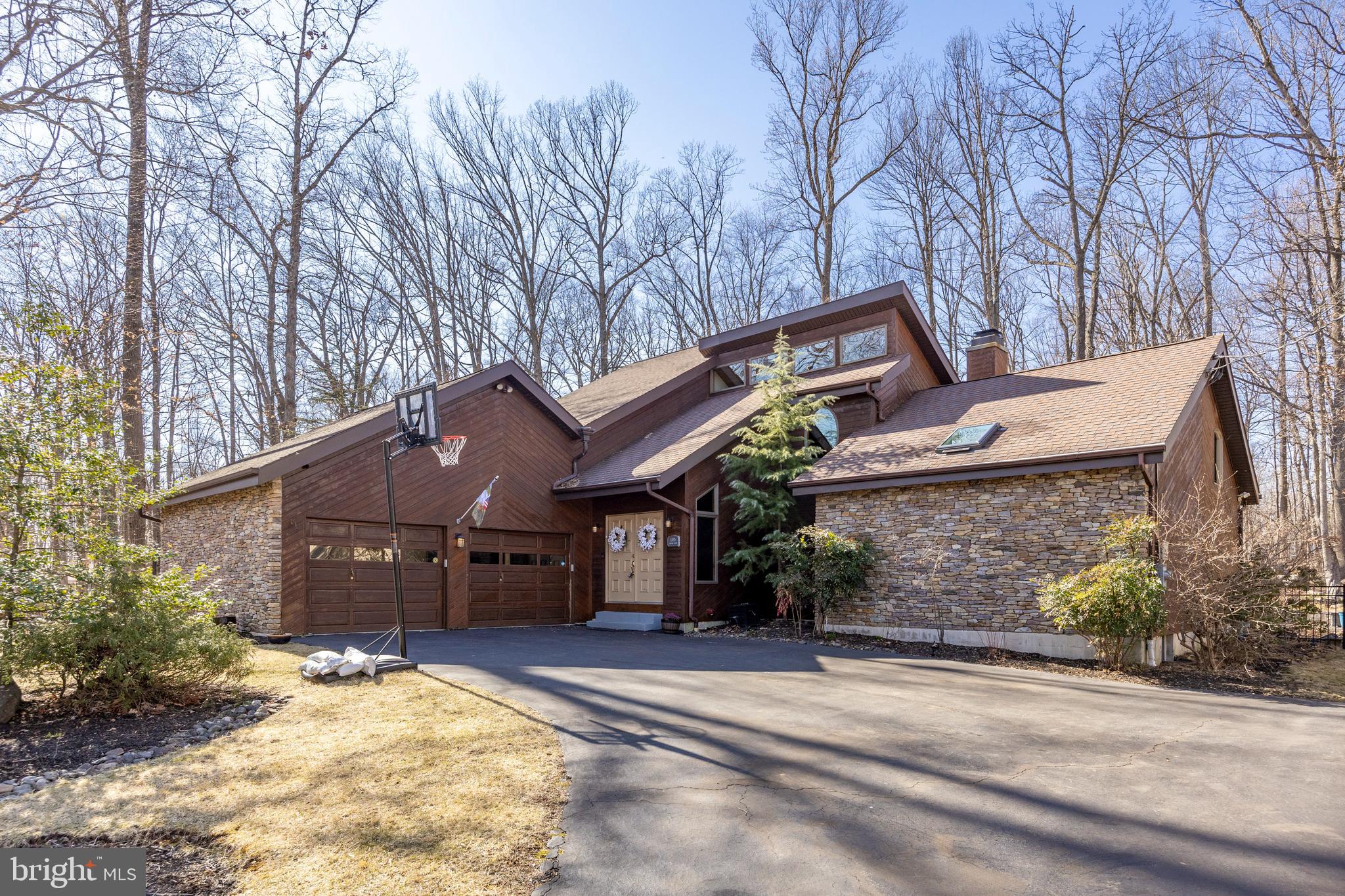 Welcome to a small piece of paradise! Your beautiful home is situated on a well landscaped, wooded 1 acre lot in Pottsgrove School District boasting 3 bedrooms (4th bedroom in finished basement), 3.5-baths in an open floor plan with luxurious features and thoughtful touches. Solid wide-planked Oak flooring grace the first floor creating a warm environment for gathering with family and friends. Vaulted ceilings open to the second-floor railings create an open and airy atmosphere. The recently renovated kitchen features stainless steel appliances, an oversized leathered quartz island, beautiful large cabinets, a double kitchen and additional bar sink (both with garbage disposals) and a double oven; all contributing to the perfect environment for creating culinary delights. A wood burning fireplace and 2 sets of French doors compliment the beautiful living and dining area. The primary suite on the main floor of this lovely home is complete with vaulted ceilings, walk-in closet, and an ensuite bathroom, featuring a pedestal tub, tiled stall shower with frameless shower door, and double vanities with built-in medicine cabinets. Enjoy your morning coffee on the expansive deck, accessible from both the primary suite and living area. Your sunken bullfrog hot tub will help you relax on those cool evenings while overlooking your private oasis; your beautifully landscaped and wooded back yard. The large laundry room with new appliances and built in cabinets and pantry complete the main floor of this home. Upstairs, you’ll find two additional large bedrooms connected by a convenient Jack and Jill bathroom with oversized closets including a hall linen closet. The overhead hallway includes a charming reading nook with an oval window which provides natural light and a cozy area to study, sew or meditate. The finished basement includes a fourth bedroom and full bath, a home workout area and large family room complete with a built-in desk area. Numerous large closets including a cedar closet provide tons of storage. The three seasons room located off the main living area offers more opportunity to enjoy the outdoors in comfort and leads outside onto the large Trex deck where you can entertain family and friends. A custom shed, which matches the style of the home, allows plenty of storage space for all your gardening needs. Landscape lighting enhances the exterior beauty of the property, while inside, energy-efficient LED lighting illuminates the home. The remodeled oversized two car garage is complete with a Gladiator cabinet system providing ample storage and organization options. Two Chamberlain MyQ smart garage door openers allow monitoring and operation from your phone. The Ring doorbell, and multiple Nest security cameras will allow you to feel secure and monitor your home while away. Exterior lighting is conveniently controlled by WEMO smart switches allowing you to illuminate your home from your phone. A home water treatment system includes a UV light installed to ensure you can enjoy clean and pure water. This impeccably maintained home is truly a hidden gem conveniently located close to shopping, schools, major routes and recreational areas to allow easy access to work, shop and play. Don't miss this opportunity to make this home yours and begin relaxing and entertaining in your hidden oasis.