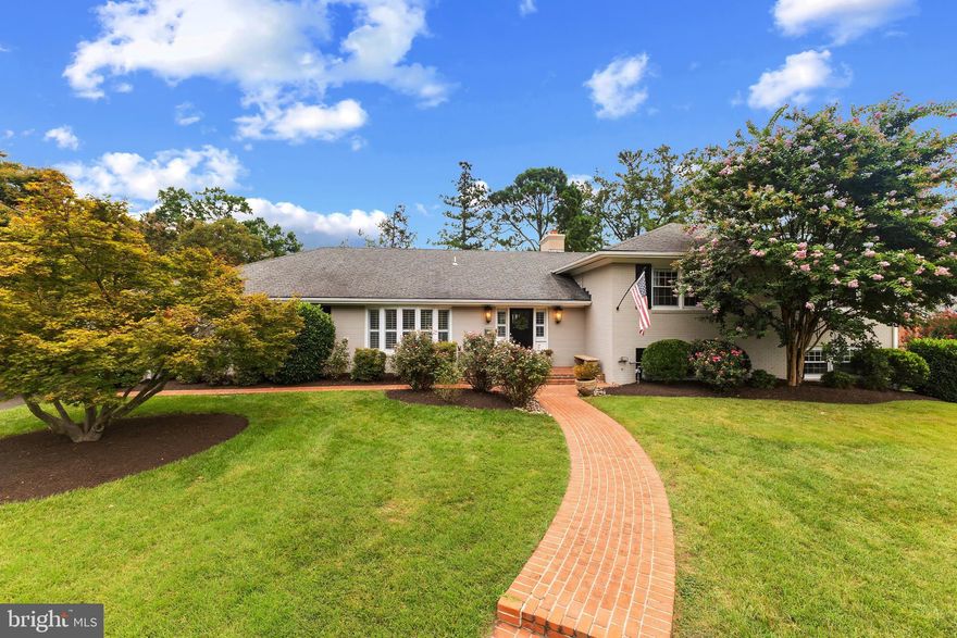 Welcome to 1214 Belle Vista Drive, a sprawling three-level all-brick home located on one of the most premier streets in Alexandria's sought-after Villamay neighborhood! Boasting 3,294 sqft on a .35-acre flat lot, this stunning home offers 4 bedrooms and 3 updated bathrooms, just minutes from local parks, the Potomac River, and historic Old Town Alexandria. Set on a quiet street, the home offers exceptional curb appeal and privacy, with a rear entrance 2-car garage, enhanced landscaping, a new flagstone patio in the fully fenced backyard, and a motorized gate at the driveway.  Inside, enjoy hardwood floors, recessed lighting, window treatments, crown molding, and neutral paint throughout.  Natural light fills the main level as the front living room welcoming guests with large windows overlooking the backyard. The gourmet kitchen features granite countertops, stainless steel appliances, white cabinetry, updated fixtures, subway tile backsplash, and space for a breakfast table with sliding doors to the back patio - making indoor to outdoor entertaining easy! Adjacent to the kitchen is the formal dining room with a bar/butler’s station and a side exterior door to the driveway. Between the kitchen and dining room is a convenient mudroom with cubbies and coat hooks to provide the perfect drop zone when coming in from the 2-car garage. Upstairs, you’ll find three generous bedrooms, each with window blinds and ceiling fans.  The spacious primary bedroom offers a large walk-in closet and the expanded spa-like primary bathroom includes a large double vanity with granite countertops, a glass-enclosed walk-in shower, separate toilet room and linen closet. The updated hall bathroom offers dual sinks, a tub shower and another linen closet. The walk-out lower level features an expansive recreation space with a cozy corner stone fireplace and a separate side-yard entrance. This level also includes the fourth bedroom, a third renovated full bathroom and laundry room.  Recent upgrades include: New Hot water heater; New washer/dryer and dishwasher; new flagstone back patio with stone wall; new rear landscaping and rear fence with motorized gate for vehicles. This home offers the ultimate neighborhood location on a flat part of Villamay’s gorgeous winding streets, just steps from McCutcheon Park & Playground and a short drive to Hollin Hall or Belle View shopping centers for local grocery, convenience stores, and restaurants. Enjoy living near the George Washington Parkway with easy access to bike trails, parks, and convenient commuting to Washington, D.C., the Pentagon, Old Town Alexandria, and National Airport. Incredible opportunity in Villamay!!