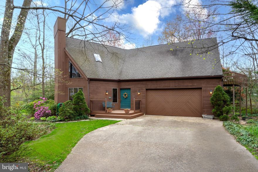 ***OPEN  HOUSE CANCELED for Saturday 4/20***   CUSTOM WOODLAND CRAFTSMAN showcasing masterful ORGANIC TEXTURES & DETAILING to blend aesthetically into its LUSH NATURAL SURROUNDS! SOARING CEILINGS and custom windows maximizing natural light and ever-changing seasonal views.  OUTDOOR DECK for alfresco dining & relaxation accompanied by birdsong symphonies!  Amenity rich, water privileged BERRYWOOD offering a Cattail Creek/Magothy River healthy, active lifestyle.  Dramatically vaulted main level with wood-planked ceiling, multistory stone fireplace, and open concept Living/Dining Room/eat-in Kitchen spilling out to deck.  Hardwood & tile floors, updated appliances & fixtures, modern lighting, & neutral paint palette to enhance any décor.  Main level Bedroom/Bath/Laundry for possible In-law Quarters!  Flexible Home Office or Den.  Awe-inspiring upper level catwalk overlook connecting the vaulted Primary Bedroom/Bath Suite haven with open air balcony to a separate wing hosting 2 additional airy Bedrooms, and Full Family Bath.  Finished lower level Family/Rec Room and utility/storage area.  Multi-vehicle driveway; 2-car garage.  Coveted Berrywood with resident piers, small craft launches & storage, pool w/clubhouse, tennis, playground, & sports' courts!  Convenient to metro amenities including parks, premier mall shopping, eclectic dining, Chesapeake Bay boating, the USNA, and commuter routes 50/97/2. A mere 20 minutes to both Baltimore & Annapolis bustling harbors!  A VERY, VERY BERRYWOOD EXCLUSIVE!