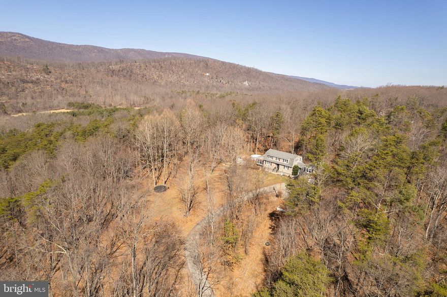 Charming 3-Bed, 2-Bath Dutch-Style Home on 4.79 Acres! This spacious 2,400+ sq. ft. home offers a perfect blend of rustic charm and modern convenience. Nestled in nature, enjoy abundant wildlife, a peaceful creek with waterfalls, and multiple firepits for outdoor gatherings. The main level features a bedroom with a full bath, a kitchen with tile floors and stainless steel appliances, and a cozy living room with a pellet stove and exposed wooden beams. Step outside to relax in the above-ground pool or explore the scenic property. The home boasts recent updates, including a new well pump (2019), roof (2017), septic pumping (2017), updated siding & walkway, and sump pump. A large garage with a wood stove provides ample storage and workspace. Experience the beauty of country living with modern comforts—this property is a must-see!