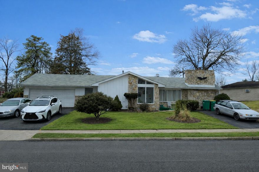 This handsome mid-century classic design with twin driveways and deep garage offers opportunity for transformation. A handyman's dream home. Enter a flagstone enclosed foyer to an open floor plan that flows from Living room to Family room featuring a full wall stone fireplace. This room opens to a formal dining room off the kitchen.  Glass doors open to a sunroom with direct access to the backyard patio from the sunroom.  3 ample size bedrooms  and full bath with tub/shower.  Pull down stairs to full attic storage. The deep garage has an service door to the back patio.  Don't miss the enclosed patio garden accessed from the Dining room glass doors!