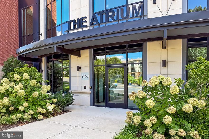 Refined luxury living!  •  Welcome to the Atrium at MetroWest - An exclusive 55+ community with amenities galore: Sparkling heated indoor pool / Clubhouse/Entertainment room w/recurring community gatherings & a full kitchen for events / Well-equipped Gym includ a dedicated Yoga room / Beautiful Courtyard with grilling & dining spaces / Library  •  Imagine yourself in this beautifully appointed, turn-key 1 Bedroom + Den, 2-Bath condo  •  Loaded w/high-end finishes & upgrades  •  A whopping 1,546 sq ft of living space  •  TWO garage parking spaces, both are only steps from the elevator - One PREMIUM spot ($30k upgrade)  •  RARE find: NO shared walls ensures quiet living  •  Plus, constructed of solid concrete above and below allows for hardwood floors throughout the residence  •  Conveniently located with direct access to all of the amenities makes participating/enjoying the community's offerings even easier  •  Enter through the foyer and be welcomed by the beautiful hardwood floors that flow throughout the entire condo  • The gourmet Kitchen features quartz countertops, a large center island with bar seating perfect for entertaining, stainless steel Kitchen Aid appliances & a pantry closet  •  Off the kitchen, is your  private balcony perfect for morning coffee or winding down at the end of the day  •  Open floor plan flows seamlessly from the Kitchen to Dining and Living Room  •  Natural light floods the main living areas with its walls of windows  •  Primary Bedroom boasts hardwood floors, two oversized walk-in closets, spa-like bath w/a stylish double sink vanity, walk-in glass shower, separate water closet & linen closet  •  The spacious Den/Flex Room perfect for home office or guest suite resides in its own "wing" and is adjacent to the second full bathroom w/walk-in shower  •  Full size laundry closet & 2 additional coat/storage closets  •  An additional, spacious storage room is deeded to the property, offering extra space for seasonal items  •  Ample visitor parking accessed with coded garage entry makes for a seamless experience for guests  •  SUPREME LOCATION: Conveniently located next to the Vienna METRO and just moments to I-66  •   Nearby downtown Vienna and Mosaic District offer endless options for shopping, dining, and entertainment  •  Adjacent to several parks and walking trails, enjoy the serene nearby greenery and nature with easy access to trailheads  •  Love where you live - Welcome home!