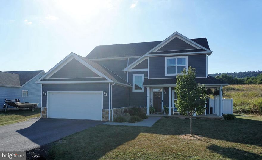 Beautiful Arts & Crafts  with wrap around front porch & real stone waters table- 3 levels with 4 bedrooms/ 3.5 baths in the Butlers Bridge Community- Built in 2020 - This home offers 3 finished levels- Open floorplan with spacious great room with cozy propane/gas fireplace, formal dining room with tray ceiling & Designer Shaker kitchen with oversized 8 x 4 granite island, stainless steel appliances, 2 piece crown molding, two tone paint, main level LVP flooring, Hardwood steps to upper level, Upper level features 3 bedrooms-Master with tray ceiling & large walk in closet, Master with ensuite luxury bath with dual sink vanity, 4 x 4 oversized tile shower with separate handheld and regular shower head, separate soaking tub, Lower level is fully finished with 4th bedroom, rec room full bath ,den, & areaway entrance. Rear yard is fully fenced with a white vinyl privacy fence & stamped concrete large patio. This home features a enrgy efficient Rianni Propane Tankless Water heater & 2 HVAC systems! Hedgesville School DIstrict! ALL THIS NESTLED AGAINST THE ORCHARDS & NORTH MOUNTAIN YET CONVENIENTLY LOCATED MINUTES TO 81 AT EXIT 14 DRY RUN ROAD.