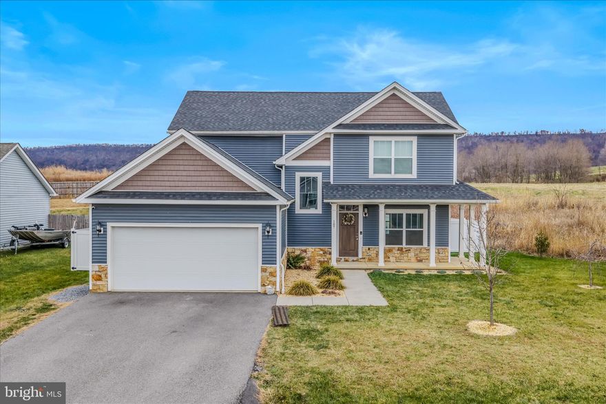 Beautiful Arts & Crafts  with wrap around front porch & real stone waters table- 3 levels with 4 bedrooms/ 3.5 baths in the Butlers Bridge Community- Built in 2020 - This home offers 3 finished levels- Open floorplan with spacious great room with cozy propane/gas fireplace, formal dining room with tray ceiling & Designer Shaker kitchen with oversized 8 x 4 granite island, stainless steel appliances, 2 piece crown molding, two tone paint, main level LVP flooring, Hardwood steps to upper level, Upper level features 3 bedrooms-Master with tray ceiling & large walk in closet, Master with ensuite luxury bath with dual sink vanity, 4 x 4 oversized tile shower with separate handheld and regular shower head, separate soaking tub, Lower level is fully finished with 4th bedroom, rec room full bath ,den, & areaway entrance. Rear yard is fully fenced with a white vinyl privacy fence & stamped concrete large patio. This home features a enrgy efficient Rianni Propane Tankless Water heater & 2 HVAC systems! Hedgesville School DIstrict! ALL THIS NESTLED AGAINST THE ORCHARDS & NORTH MOUNTAIN YET CONVENIENTLY LOCATED MINUTES TO 81 AT EXIT 14 DRY RUN ROAD.