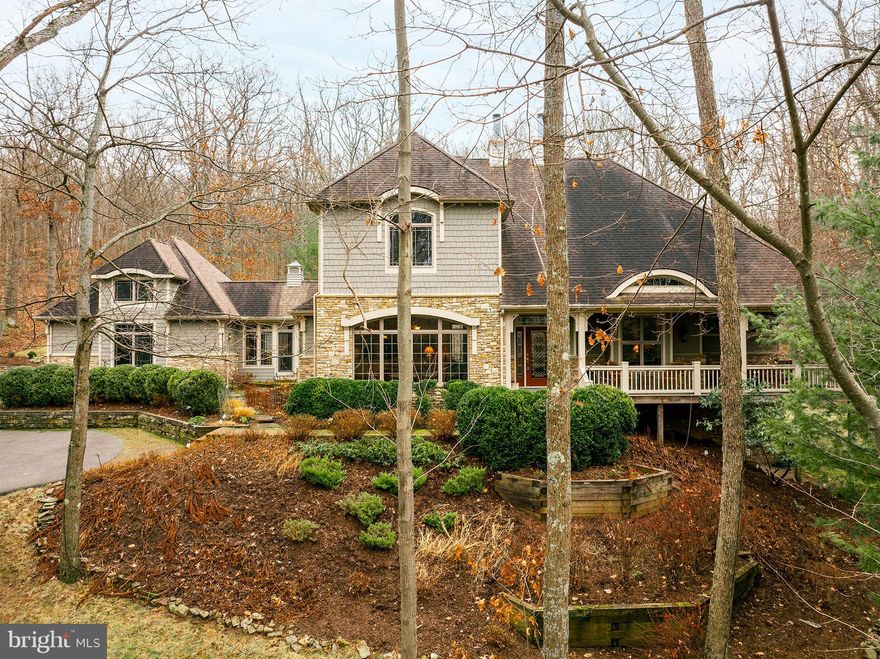 If you are looking for a stunning home from the moment you arrive, this is it. This masterpiece is warm and inviting from the moment you enter. The rustic elegance of this custom-built Nemith home is apparent no matter where you stand. The kitchen boasts a great center island with seating - beautifully detailed maple cabinets with quartz countertops and high-end appliances. The oak hardwood floors, three stacked stone wall-to-wall fireplaces, and custom over-sized baseboards with door header oak trim are just a few more features that make this home stand out. Three levels of living space for entertaining and family gatherings.  A generous covered front porch and a spacious partially covered back deck with a flagstone patio offer seasonal areas to gather and enjoy the outdoors. The lower-level storage area and a two-car attached garage with attic means you’ll never run out of space for all of your belongings and toys. The abundance of windows with upper transoms and lower awnings affords you spectacular views and brings the beautiful southern exposure sunshine in during any season. The exterior space is flanked by woods on all sides giving privacy and seasonal beauty from every window. Also offering expert landscaping, a paved driveway, and a spacious front covered porch.  If all of this isn't enough, this home also offers a ¼ interest in a lakefront parcel with a deeded dock slip that’s just a five minute walk away. Call today to preview this great home!