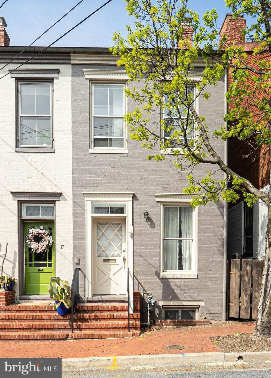 Welcome to East South Street—a rare opportunity in one of Downtown Frederick’s most sought-after locations! Just one block from Carroll Creek, Sky Stage, and Alive at Five, this beautifully renovated home blends historic charm with modern comforts, all just moments from local shops, restaurants, parks, and entertainment. Step inside to discover original wide pine floors, working transom windows, and a seamless blend of preserved character and stunning modern renovations throughout. The spacious living room features a working wood-burning fireplace and abundant natural light. The private dining room is anchored by a decorative mantel fireplace and showcases a gorgeous, curved staircase leading to the upper level. The fully updated eat-in kitchen is a true showstopper—featuring exposed brick, granite countertops, a farmhouse sink, stainless steel appliances, a gas range with hood, and crisp light cabinetry. A bonus back room with floating industrial shelving offers the perfect walk-in pantry or creative flex space, complete with its own electric heating system. A mudroom off the back door and a main-level powder room add everyday convenience. Upstairs, you'll find two spacious bedrooms with hardwood floors and newly built closets. The primary suite includes a full updated and stylish en-suite bathroom, and a new charming barn door. The second bedroom features tall ceilings and natural light. A renovated full hall bath and full-size washer/dryer are also on this level for added functionality. The third-level loft is a flexible bonus space—ideal for a home office, studio, or additional bedroom—complete with its own built-out closet. The unfinished basement offers excellent storage potential. Step outside to enjoy the fully fenced, deep backyard, a true outdoor oasis. The beautifully landscaped yard is complete with meticulously designed hardscaping, a charming stone patio perfect for relaxing or entertaining, and plenty of space to enjoy outdoor dining, gardening, or simply unwinding in nature. Mature trees provide privacy and shade, while a storage shed is conveniently placed for your gardening tools, bikes, or hobbies. Street parking is available, with the option to lease two private spaces nearby. Additional upgrades include a new roof (2020) and thoughtful improvements throughout. A unique selling point of this location is its easy access to downtown. With quick entry/exit via I-70 and a two-way street, you can avoid the congestion on Carroll/East and Market Street during events—something other downtown streets can’t offer.  With its unbeatable location, timeless character, and move-in-ready updates, this home is a standout in Downtown Frederick. Don’t miss this rare opportunity—schedule your private tour today!