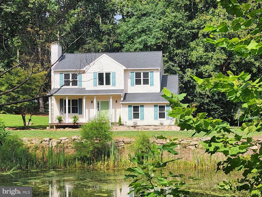 Detached home near Brambleton for under a million. Top rated schools: Sycolin Creek ES, Watson Mountain MS and Independence HS. Charming colonial built in 2001 set on a private 2.56-acre lot overlooking a natural pond and wooded backdrop. Ample space for a garden, chickens, goats, bees, or other small animals with NO HOA with (Zoned Agricultural Rural -1)  modern conveniences just minutes away:  10 minutes to Brambleton Harris Teeter grocery, Regal Cinema, shops and restaurants. 15 mins to Ashburn Metro. This 4-bedroom, 2.5-bath home with a spacious 2 car garage is truly move-in ready, with extensive updates to give you comfort and peace of mind for years to come.  A long driveway provides welcoming seclusion and leads to a picturesque property with classic gabled eaves and a front porch that overlooks the private pond. Updates include an updated kitchen (2017) with granite counters, tile backsplash, white cabinetry, and stainless steel appliances—including a brand new induction range. Porcelain tile and luxury vinyl plank flooring make cleaning easy, while abundant windows and recessed lighting fill the home with natural light and warmth. The four bedrooms are located upstairs together with the laundry. The primary bedroom is huge with vaulted ceilings, walk-in closet and a large en-suite bathroom with a separate soaking tub and double sinks. The other bedrooms are spacious with large closets and recessed lighting.  Room to park an RV, boat, or equipment.
Major systems have been smartly upgraded, roof (2022), HVAC  (2019), water heater and well system upgrades (2020), and a new well pump (2024), windows and sliding doors (2015) fresh paint (2025), repaved and expanded parking (2020), resealed driveway (2025),  reinforced deck railings and footings (2023), pond infrastructure upgrades and boulder retaining wall (2018), termite monitoring/treatment (2022), stone fireplace surround and propane-ready vented gas log fireplace (2019), and Invisible Fence (2019).   

Eight minutes to the new Hal and Berni Hanson Regional Park; 15 minutes to downtown Leesburg; 20 minutes to Ashburn metro station; 20 minutes to Dulles airport.