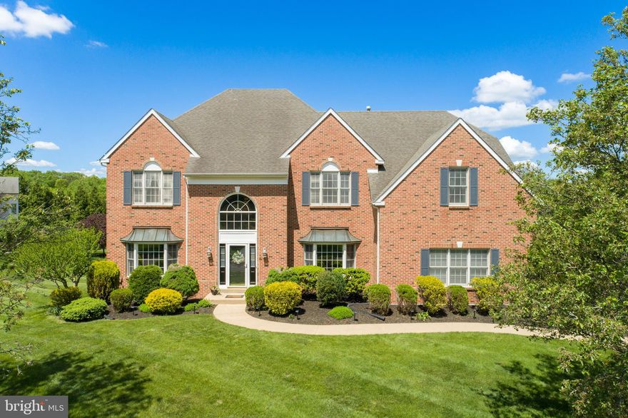 Welcome to Your Dream Home in the Estates at Windlestrae!

Nestled on a quiet, non-through street in the sought-after Estates at Windlestrae development, this stunning brick-front traditional home offers timeless elegance and modern comfort. With 4 spacious bedrooms, 3 full baths, and one half bath (plus more than 2000 square feet of additional living space in the finished daylight basement), this meticulously maintained residence is the perfect blend of style, space, and functionality.

Step into the grand foyer and be greeted by a beautiful spiral staircase leading into a pristine large kitchen—ideal for entertaining and everyday living. The kitchen flows seamlessly into a dramatic den, featuring a wall of windows, gas fireplace, wet bar, and built-in surround sound option, creating a warm, inviting atmosphere.

The first floor boasts gleaming hardwood floors, recessed lighting, a formal living and dining room, dedicated office, large laundry room, and a powder room—all designed with thoughtful detail and high-end finishes.

Upstairs, the hardwood flooring continues throughout. The expansive primary suite includes a luxurious en suite bath, a sitting room (perfect for a home office or retreat), and ample closet space. Three additional generously sized bedrooms and two full bathrooms complete the upper level.

The fully finished daylight basement adds over 2,000 sq. ft. of versatile space, ideal for a game room, gym, or creative studio. It also includes a dedicated music/theater room for unforgettable movie nights or jam sessions.

Outside, enjoy a spacious deck overlooking a flat, private yard that backs to protected land—perfect for peaceful evenings and stunning sunset views. A three-car garage with accessible storage and a whole-house generator add convenience and peace of mind.

This home truly has it all—space, sophistication, and serenity. Don’t miss your chance to make it yours.  If you're ready, let's go home.