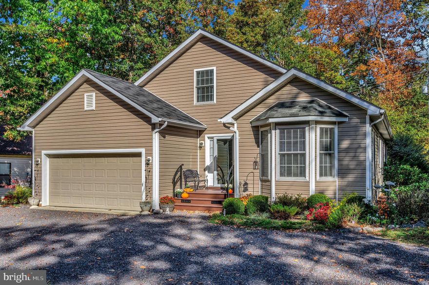 Welcome to 402 Liberty Blvd! This stunning Lake of the Woods home truly has it all. This spacious,   beautifully updated home offers a perfect blend of comfort, style, and functionality. Thoughtful upgrades throughout include all-wood flooring on both levels, a renovated guest bath, and abundant natural and recessed lighting. The spacious kitchen is a chef’s dream with quartz countertops, a large island with seating that conveys, upgraded appliances including a gas stove with double oven, built-in air fryer and convection bake, plus custom lighting to showcase your favorite glassware.

Enjoy year-round comfort with major mechanical updates: main A/C replaced with heat pump, a two-zone mini-split system serving the upper level, a high-efficiency water heater, and a two-stage gas furnace. Entertainment is effortless with a premium Bose SoundTouch 520 home theater system — fully wired and conveying with two AV cabinets — in the great room.

Outside, the landscaped yard with mature perennials and shrubs wraps around the home, while the freshly stained deck and screened-in porch provide multiple areas to relax or entertain. This move-in-ready property combines thoughtful design, quality upgrades, and exceptional value — ready for you to make it your own!

Nestled in a private, secure, gated community, Lake of the Woods is a paradise of possibilities. With two lakes, a golf course, an equestrian center, fire and rescue services, and even a church within its bounds, this community offers a diverse range of activities. From boating, water skiing, kayaking, and golfing to the simple joy of soaking in mesmerizing views from the clubhouse, deck, yard, or beaches, there's something for everyone. Engage your interests by joining over 60 clubs and organizations, or perhaps indulge in a game of bridge or contribute your talents as a volunteer. Lake of the Woods truly caters to your lifestyle.

Located in Orange County, enjoy the added advantage of low real estate taxes. With home prices spanning from $200,000+ to over $2,000,000, Lake of the Woods is the ideal haven for both full-time residents and weekenders. Don't just take my word for it – come and see for yourself! Allow me to guide you through a tour of Lake of the Woods, showcasing the very essence of what makes this community so special. Experience firsthand the captivating charm of Lake of the Woods!