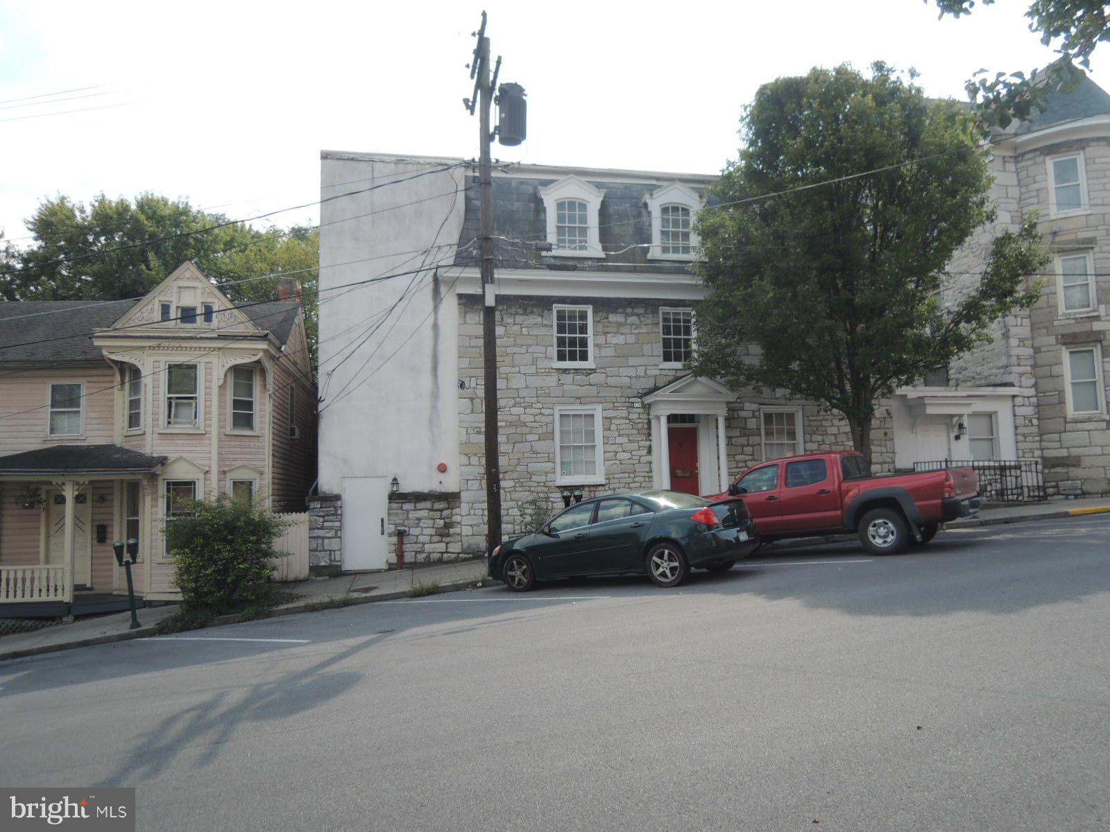 Stone building close to the downtown square! 10 BR/ Office space on 2nd & 3rd floors with 2 additional office spaces, conference room, complete kitchen, laundry room and handicap bathrooms on main floor, including up to 6 parking spaces behind building. LOTS OF POTENTIAL!! Building has a complete sprinkler system with upgraded fire and alarm systems.