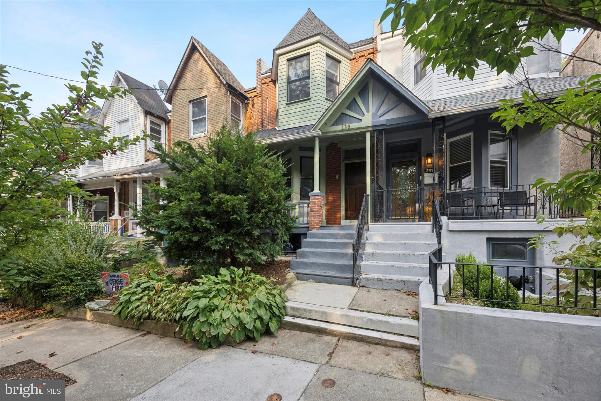Every ounce of original charm was not only retained when this right-sized house got all the right upgrades just three years ago, it was enhanced with salvaged, vintage and pitch-perfect repro details throughout. There are original pine floors, high ceilings, just-right light fixtures, Andersen windows and at least one uber-charming element in every room. The main-floor layout provides the best of both worlds–the front living room off the entry hall is a clearly delineated space all its own, while the middle kitchen, rear dining room and back yard flow together for a contemporary open-plan feel. The living room has a decorative fireplace with gorgeous original mantel plus architectural charm from the angled set of front windows. These are a nice complement to the oversized archway with original fretwork spandril. From the hall, another oversized doorway leads to the spacious L-shaped kitchen, where white Shaker-style lower cabinets and pantry let the salvaged beadboard backsplash, statement salvaged upper cabinet and a sweet original closet with glass-paned door shine. White Caesarstone countertops with undermount sink and Grohe pull-down faucet alongside stainless steel appliances, including a slide-in five-burner range and French door fridge, make this space as effortlessly functional as it is warm and stylish. The large dining room has a salvaged butler’s pantry and is flooded with light from two windows and Andersen French doors to the rear patio and lush garden. Back inside, the original staircase that has a peek-a-boo window to the kitchen leads to a rear primary suite, two more spacious bedrooms and a hall bath. The primary bedroom with a large double closet offers a peaceful view of the rear garden; its en-suite bathroom has a marble herringbone tile floor, clawfoot tub with full-wall subway tile surround, and salvaged beadboard around a vintage-inspired wall-mounted sink with chrome legs. The front bedroom is quite spacious and has a large closet; its charm is found in the square bay window. The middle bedroom is easily big enough for a double bed, if not a queen, and has an extra-deep closet. They share a hall bath with skylight, marble herringbone tile and full-wall subway wall tile, an extra-large step-in shower and pedestal sink flanked by ceramic lights. The exterior has every bit as much charm as the inside: Set behind a front garden, the handsome porchfront’s exterior has a subdued sage green and gray palette that highlights the architectural details, and an unpainted original front door. And as a huge bonus, through the rear gate is an unofficial parking spot and a sweet neighborhood hang space complete with firepit. This great location puts both Germantown and Mount Airy favorites like Weaver’s Way, Ultimo Coffee, Uncle Bobbie’s, and of course access to the Wissahickon, all within a mile of your front door–and the Upsal St Regional Rail station only .3 miles away.