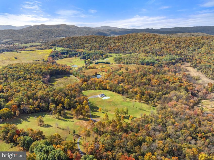 Discover Pohick’s Corner — a stunning 96-acre country retreat in the heart of Virginia’s horse and wine country, just one hour from Washington, D.C. Set amid rolling hills and preserved landscapes, this exceptional property offers both serenity and opportunity.

Protected by a Fauquier County conservation easement, Pohick’s Corner and its neighboring property will forever maintain their breathtaking views and rural charm. The easement allows for the construction of an additional 6,000 sq. ft. home and multiple outbuildings — imagine your dream estate with space for a garage, barn, sheds, or pool house — all while enjoying the existing cozy cottage pool house and low taxes.

Built in 2023, the four-bedroom home combines comfort, accessibility, and craftsmanship. Designed for one-level living, it features ramps, wide doorways, and open spaces ideal for easy movement. Inside, you’ll find vaulted and 9ft ceilings, hardwood floors throughout, and marble floors in the kitchen, half bath, and laundry room. A constant-pressure, variable-speed pump delivers water from the 100-gallon-per-minute well, and the five-bedroom septic system allows for future expansion. Step outside to the two-lane lap pool with a zero-entry ramp, perfect for relaxing or daily exercise.

The land itself is a rare find — 96 acres of rich, diverse soils, ideal for pasture, grazing, or crops, bordered by two creeks and containing a natural spring.

Whether you’re looking to create a private compound, a luxury farm retreat, or simply enjoy country living with modern comfort, Pohick’s Corner offers it all — unmatched privacy, natural beauty, and endless potential.