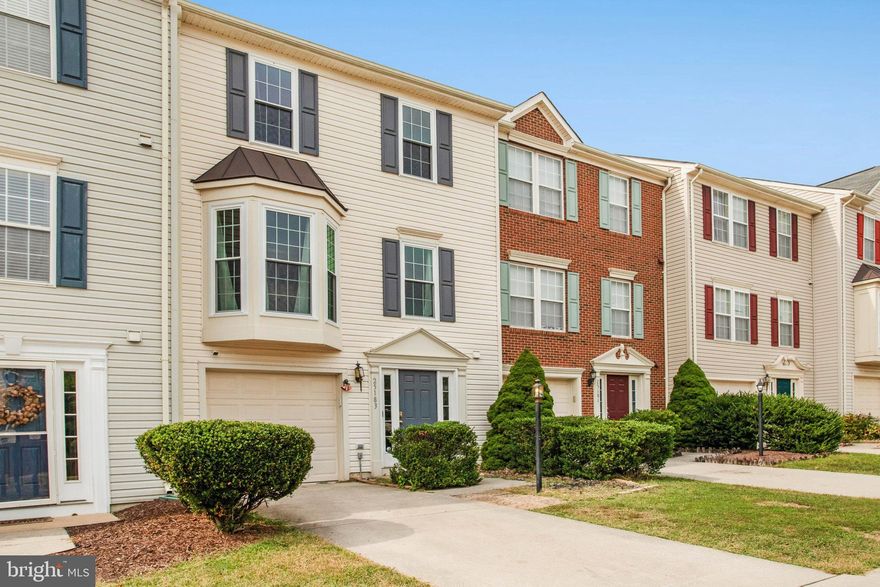 Welcome home! This lovely townhome offers an open layout and light-filled spaces on all three levels. On the main level, you’ll find a beautiful bay window flooding the living room with abundant natural light, with plush carpeting under your feet and a bonus nook perfect for a home office or play area. On the back of the home, the expansive eat-in kitchen features plenty of cabinet space, with a central island and an additional wall of cabinetry in the dining area. Upstairs, the generously-sized primary bedroom suite boasts a large walk-in closet and a private en suite bathroom with a double sink vanity. Two additional bedrooms are sizable, with soft carpeted flooring and shared access to the second full bathroom in the hallway. Downstairs on the entry level, you’ll find a large storage room and garage access, plus a convenient powder room. Outside, the wide deck overlooks open common space, creating a peaceful and private setting for morning coffee or outdoor dining. On the front of the home, the attached garage and driveway offer you plenty of space for both storage and convenient parking. Enjoy fantastic neighborhood amenities including an outdoor pool, tennis courts, basketball courts, a community center, and open common grounds. All this, plus a prime location close to major commuter routes, shopping, and dining. Schedule a private tour of your new home today!