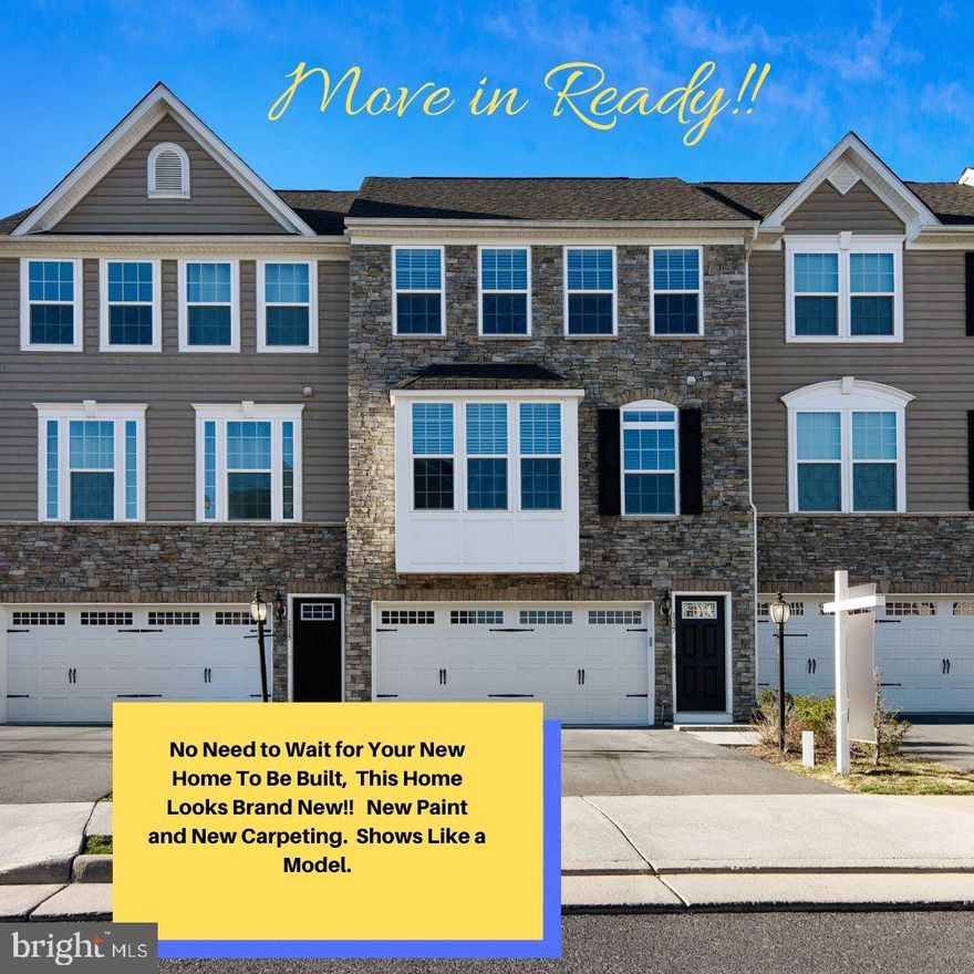 Not part of the 55+ Restrictions.  NO need to wait for your new home to be built.  5 Year Young,  2 Car Garage,  Stone Front Town home, backing to the Lake!!!  This one is being freshly painted and is sparkling clean!     The kitchen level of this home has beautiful 5" Hardwood Flooring,  Huge Central Kitchen with Island,  granite counter tops, and very complimentary back splash, along with stainless steel appliances.   There is also a powder room on this level.  To the left of the kitchen, is a 21' x 13' Great Room with Large Bay/Atrium Window.  (Could be perfect for that window seat that you've been wanting).  To the right is a 21' x 11.4' Dining Room with access to a large rear deck.  The Deck backs to a view of trees and Lake Frederick.     Upper Level has your very generous sized, 15' x 14.7' Master Bedroom with its own private bathroom (soaking tub, separate shower, double bowl sinks).  Two additional bedrooms with a shared bathroom, as well as your bedroom level laundry room.     The garage level has a large 21' x 14.9' Recreation Room with access to the rear yard as well as a full bathroom.  The garage is also finished.