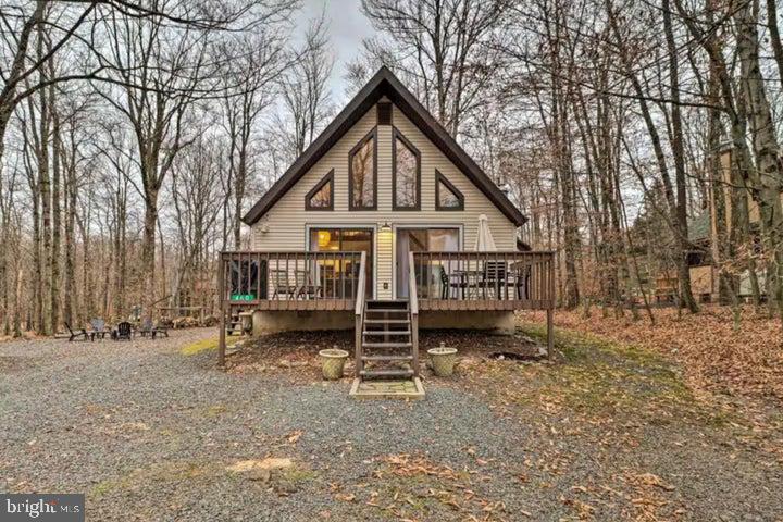 Charming Chalet on a Double Lot in Arrowhead Lakes! Tucked away on a beautifully wooded 0.58-acre double lot, this inviting chalet offers the perfect blend of privacy, comfort, and year-round natural beauty—just a short stroll from the Choctaw Pool. Smart Home Features are digital thermostat, digital front door. beautiful butcher block countertops, stone-faced wood burning fireplace. 3 nice size bedrooms, all well lighted by mother nature. Enjoy friends and family around the fire-pit. This double lot ensures you plenty of room to grow. New Flooring, New Tile, vanities and toilets. Knee walls in upstairs bedroom new, Kitchen counters and sinks new, Oven Microwave, Toaster and Fridge. New Dishware, mugs, glasses. Upgraded All interior furnishings, rugs, fixtures and decor. Newly painted, added washer /dryer Smart Electronic lockbox, Rechargeable External Camera, Power-blanket for propane, All new deck furniture. Located in the secure, gated community of Arrowhead Lakes, this home is ideal as a relaxing vacation retreat, a cozy full-time residence, or a lucrative short-term rental. Inside, you'll love curling up by the wood-burning fireplace (installed in 2013), which adds both charm and warmth while helping to lower heating costs. The loft features a convenient full bathroom, offering added flexibility and comfort for guests or family. Step outside to a spacious yard designed for fun and relaxation—perfect for summer BBQs, games like corn-hole and horseshoes, or simply enjoying the peaceful setting with loved ones. With frequent visits from deer, birds, and even the occasional bear, nature lovers will feel right at home. As part of the Arrowhead Lakes community, you'll enjoy 24/7 gated security, access to swimming, boating (non-motorized), a welcoming clubhouse, and well-kept roads and amenities maintained by the HOA. Don't miss your chance to own a slice of Pocono paradisethis chalet is the perfect escape and an excellent investment opportunity. ''Square footage based on public records''.