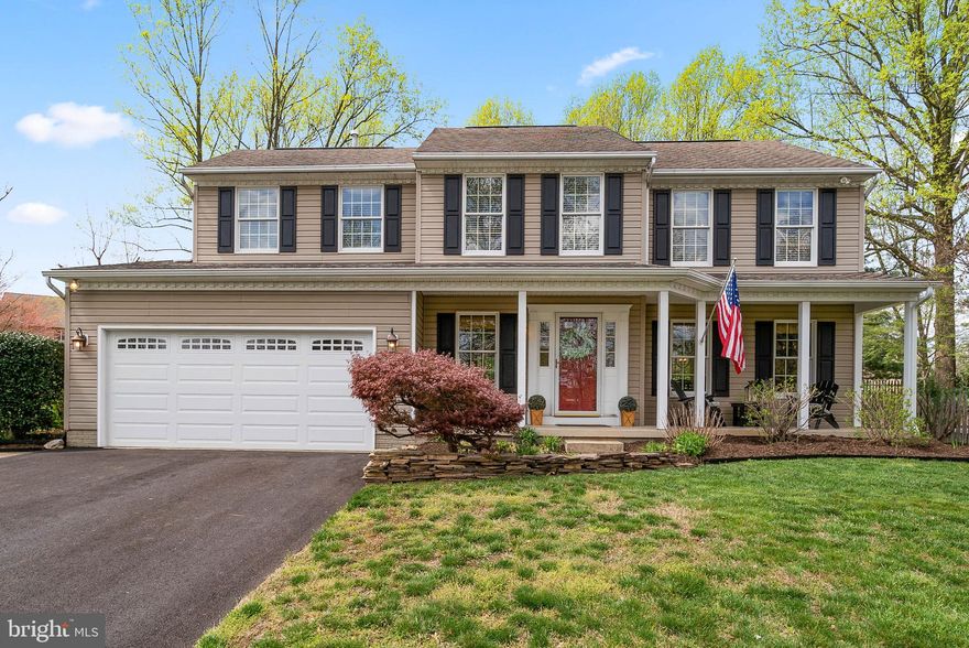 Stunning colonial features a covered front porch entry, crown molding, chair rail trim, a formal living room, a formal dining room, and a sundrenched family room showing a soaring cathedral ceiling with skylights and a brilliant bay window. Eat-in kitchen boasts granite counters, glass subway tile backsplash, classic white cabinetry, stainless steel appliances, and a breakfast room that opens to the patio and backyard. Upper level hosts 4 bedrooms including the owner's suite displaying a walk-in closet, a ceiling fan, and an upgraded bath. Additional space for leisure and entertainment is provided in the lower level presenting a full bath, a rec room with a large custom bar, plentiful storage, and a walk-up to a verdant yard. Exterior amenities include a patio, a garden shed, a fenced backyard, raised garden beds, yielding Blueberry bushes, flower beds, and a Koi pond.
