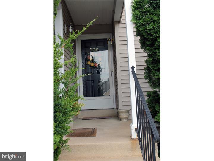 Don't miss this lovely Ballinahinch first floor condo! Hardwood floors(2005), central air, replacement windows, finished basement...this one has it all! Entry Foyer with coat closet, Kitchen has newer stainless steel appliances(2005) & breakfast bar. Large Living room with wood-burning slate fireplace, access to deck/balcony with view of woods. First Bedroom has large closet, hall full bath w/ceramic tile floor plus a stall shower. There is a laundry closet with stacked washer & dryer. Main Bedroom boasts a HUGE walk-in closet & full bath with tub. Basement is full, beautifully finished & includes furniture, storage room with utilities, 40 gal gas h/w heater '05. Includes 1-yr home warranty.