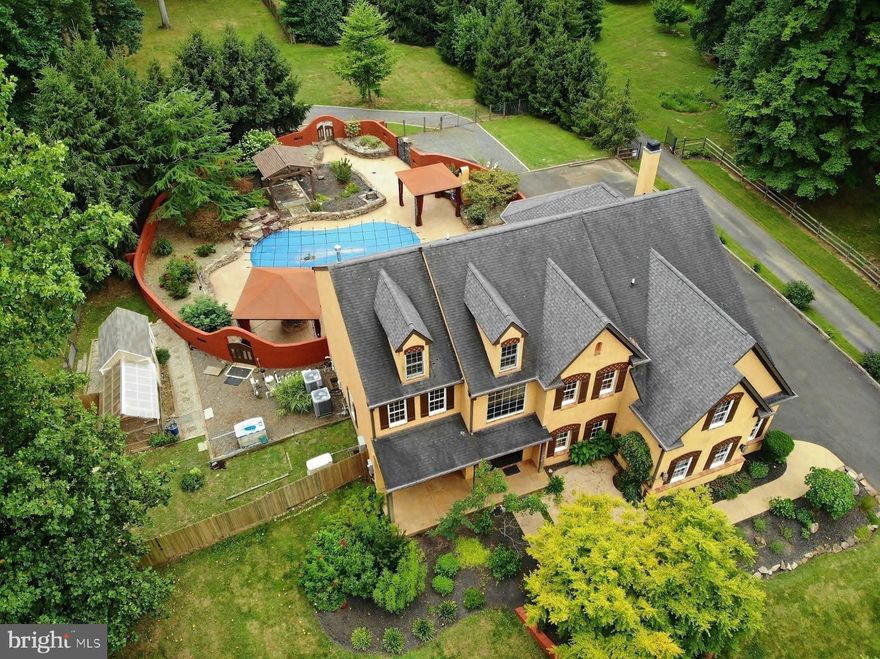 Price reduction alert! This stunning home is now available at a new, lower price—don’t miss out! Welcome to this magnificent single-family home in the prestigious Historic Doylestown area. Inspired by Mediterranean decor, it features striking arches, hand-crafted doors, crown moldings, and barrel-shaped ceilings that add artistic flair and high ceilings throughout the interior.

Located within the acclaimed Central Bucks School District, this luxurious property sits on 1.67 acres of meticulously landscaped grounds. Backing up to serene woodlands and offering expansive open land, it's perfect for nature lovers and pet owners, with ample space for accommodating horses or parking trucks, company cars, and boats.

Enhancements to the original floor plan include a spacious pantry for bulk storage and a walk-in humidor ideal for cigars, books, or spices. The home boasts 4,451 square feet of living space plus an additional 1,200 square feet in a beautifully finished basement. It features five spacious bedrooms, each with a walk-in closet, and five luxurious baths. The grand two-story foyer highlights custom artisan features, hardwood floors, a custom-designed staircases, and a hand-carved mahogany mantel.

The gourmet kitchen is a culinary haven with top-of-the-line upgrades, custom cabinets, granite countertops, a center island, Wolf gas cooktop and double oven, warming drawer, Sub-zero refrigerator, and an Old World Turkish tile backsplash. A breakfast area overlooks the rear yard, with an 8' wide sliding glass door enhancing natural light and functionality.

The elegant living room transitions to a large dining room, ideal for holiday gatherings. The family room features a gas fireplace, a butler’s pantry with an illuminated onyx countertop, wood floors, vaulted ceilings, and trapezoid windows offering stunning views and ample light.

The master bedroom boasts vaulted ceilings, a sitting room, and a double walk-in closet. The master bath includes a double vanity, Kohler jacuzzi, heated floors, a rain system shower, and a separate shower stall.

Set on a 1.67-acre flat lot, the property includes a saltwater in-ground pool with a cascading waterfall and Jacuzzi, two gazebos, a fenced backyard, and wood and storage sheds. Additional features are a front porch, office, whole-house natural gas generator, heated 3-car garage, and parking for 10+ cars. Two fireplaces—one in the family room and another in the finished walkout basement—provide warmth and ambiance. The basement also includes a bedroom, game room, full bathroom with heated floor, large laundry room, and utility room, with extended 14" treads for safer access. The finished basement offers versatile possibilities, perfect for creating a Mother-in-law apartment or an Au Pair suite. Explore the potential to tailor this space to your specific needs. We invite you to visit the property to experience its true charm and features firsthand. Some images are digitally staged to inspire your imagination.
Experience privacy and security within the fenced backyard. Freshly painted interiors create a vibrant atmosphere.  
Enjoy the comfort and elegance of this space while verifying with the township for any land use regulations or restrictions to fully realize its potential.  
Conveniently located for commuting to NY, NJ, and Philadelphia, and near restaurants, shopping centers, museums, theaters, parks, train stations, and airports. Book your appointment today! Move-in! Now is the perfect time to make it yours!"
