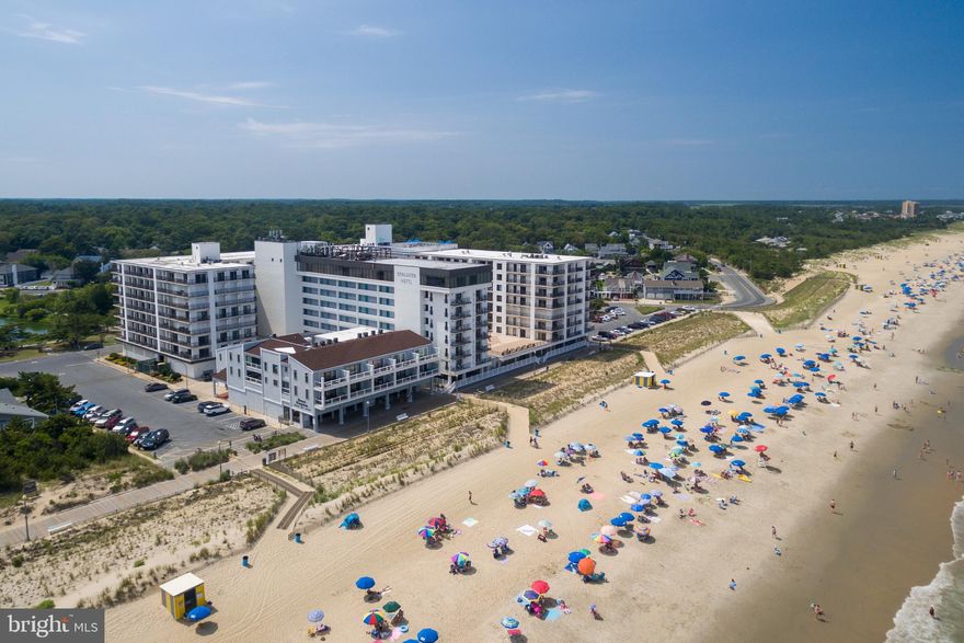 Rare opportunity to own a 3 bedroom condo in the iconic building.  From the main living areas to the private balconies, the shoreline is always in sight. The flexible layout includes a modern kitchen, spacious dining area, and living space designed for entertaining or quiet retreat.  The Henlopen provides unmatched amenities: a rooftop pool overlooking the Atlantic, beach access with outdoor showers, underground parking, elevators, and 24-hour security. Step outside to the sand and surf, or stroll into town for dining and shopping. With condo fees covering Wi-Fi, cable, water, sewer, and more, this is the ideal year-round escape in one of Rehoboths most coveted oceanfront addresses. Proven rental income with rental history on file.