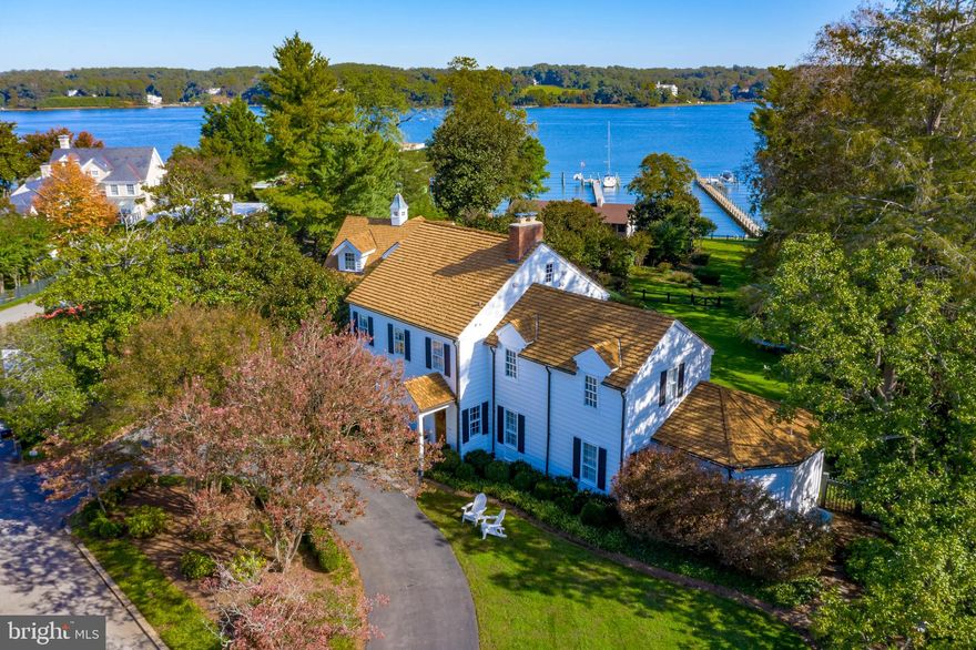 Annapolis waterfront home, built in 1948 by shipbuilder John Trumpy, sits on over an acre along the Severn River in the community of Wardour. Enjoy the ultimate entertaining space with waterside pool, outdoor kitchen and dining, large deck, and full pool bath. Embraced by boxwoods, crape myrtles, hydrangeas and gently sloping lawn to the water, 85 feet of water frontage, private pier with 3 deep water slips, boat storage cabana, and quaint potting shed. Updated, comfortable, coastal waterfront styling this home Offers 5 bedrooms and 6.5 baths  including a redesigned owner's suite.  Kitchen with fireplace and adjacent family  room, formal dining and living rooms, plus library with built-ins. The walkout lower level includes a 2nd family room, wine storage and sauna. The Amish built two-car garage has a spacious private studio above with 2 open lofts, full bath and balcony overlooking the pool.