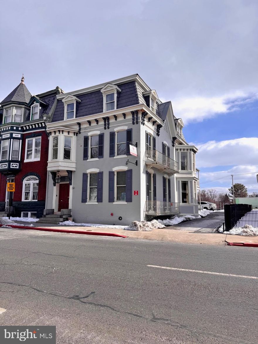 Discover the timeless elegance and exceptional potential of this grand Colonial residence, ideally positioned to capture the best of downtown living. Previously used as an accounting firm/office. Offering an impressive 4,248 square feet, this stately home showcases remarkable architectural character rarely found today — from floor-to-ceiling and bay windows to pocket doors, interior shutters, leaded glass accents, and beautifully detailed ceramic tile. Inside, the gracious living and dining rooms are separated by pocket doors and provide the perfect setting for entertaining, while the upper level features five generously sized bedrooms, offering flexibility for family living, guest accommodations, or home office space. With some updates and personal touches, this property presents a wonderful opportunity to enhance its historic beauty while adding modern comfort and value. Outside, charming sidewalks frame the property and contribute to the neighborhood’s classic appeal. Off-street parking and convenient driveway access make daily living effortless — a true advantage in this sought-after downtown location. Situated in a vibrant community within walking distance of Meritus Park (The Flying Boxcars baseball stadium), local parks, downtown coffee shops and restaurants, schools, and The Maryland Theater, this home offers both character and convenience. Whether you’re looking for historical brilliance or to thoughtfully modernize its interiors, this remarkable residence is ready to become something truly special. The seller is offering $20,000 in seller concessions! Property is zoned CCMU - buyer to verify residential use.