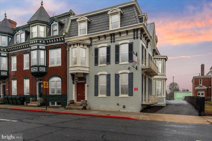 Discover the timeless elegance and exceptional potential of this grand Colonial residence, ideally positioned to capture the best of downtown living. Previously used as an accounting firm/office. Offering an impressive 4,248 square feet, this stately home showcases remarkable architectural character rarely found today — from floor-to-ceiling and bay windows to pocket doors, interior shutters, leaded glass accents, and beautifully detailed ceramic tile. Inside, the gracious living and dining rooms are separated by pocket doors and provide the perfect setting for entertaining, while the upper level features five generously sized bedrooms, offering flexibility for family living, guest accommodations, or home office space. With some updates and personal touches, this property presents a wonderful opportunity to enhance its historic beauty while adding modern comfort and value. Outside, charming sidewalks frame the property and contribute to the neighborhood’s classic appeal. Off-street parking and convenient driveway access make daily living effortless — a true advantage in this sought-after downtown location. Situated in a vibrant community within walking distance of Meritus Park (The Flying Boxcars baseball stadium), local parks, downtown coffee shops and restaurants, schools, and The Maryland Theater, this home offers both character and convenience. Whether you’re looking for historical brilliance or to thoughtfully modernize its interiors, this remarkable residence is ready to become something truly special. The seller is offering $20,000 in seller concessions! Property is zoned CCMU - buyer to verify residential use.