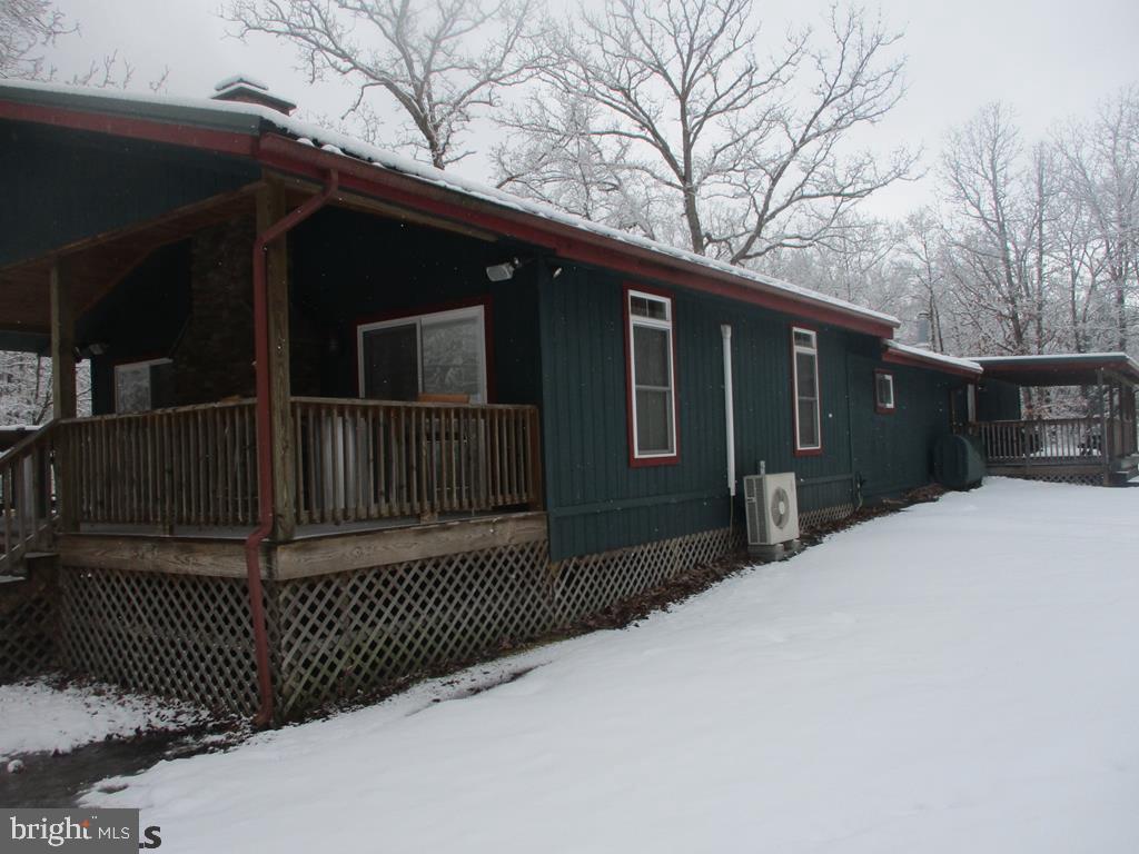 Beautiful cabin on 20 acres over looking Black Moshannon Creek (stocked) and borders RAILS to TRAILS. The cabin offers 2214 square feet of living area. The property offers several heat sources: oil forced hot, split heat pumps with central air, L.P. gas wall units and a fireplace. Full bathroom with shower. L.P. gas refrig and stove. Enjoy the large family room with fireplace, big screen T.V. and pool table. The property has three covered porches, one overlooking the fishing dock the other enjoy watching the Rails to Trails activities. Enjoy the 15' x 34' covered pavilion next to the open yard and creek. Ideal property and location only 15 minute drive to Black Moshannon State Park which offer swimming, boating and all of the Parks activities. Call for complete details.