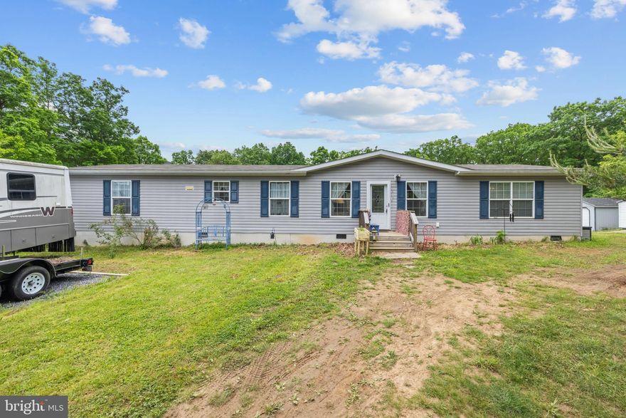 Serenity found in this lovely 4 bedroom 2 bath on just over 2 acres at the end of the road.      This 2018 Clayton Home is on a permanent foundation boasting  all the home features of a stick built home. The large living room features a sliding glass door that open up to a deck (awaiting completion).   Ample counter and cabinet space  in the kitchen, large island, and  room for a cozy kitchen table. Enjoy a lovely ensuite bath  and walk-in closet in the primary bedroom. The other three bedrooms are thoughtfully positioned at the opposite end of the home, sharing a full bath.    Laundry room has exterior door onto a large deck.  Two sheds give you lots of room for storage of yard or garden equipment.  Large open back yard with fenced in garden area that needs your loving touch to bring it back to live.  Lovely trellis overflowing with wisteria.   Wildlife seen frequently crossing the yard.  Home is being sold AS-IS. RV does not convey.  If someone desires more acreage, there is a 5.24 acre lot for sale (WVHS2003830) to the left of the house, listed by Mountain State Properties of WV.