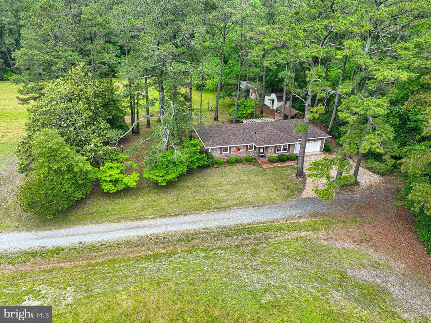 Nestled among the pine trees, this charming brick-front rancher offers peaceful country living on approximately 10 open acres, most of which are currently in crops. The traditional floor plan features a front living room, rear kitchen and den combination, laundry room with full bath, and two bedrooms with an additional full bath located on the opposite end of the home.
The property is filled with natural beauty and established plantings including fig trees, pecan trees, and grape vines. Enjoy abundant wildlife with frequent sightings of deer and wild turkey right from your backyard. Conveniently located within 20 minutes of Ocean City, this property offers the perfect blend of rural tranquility and nearby coastal attractions.