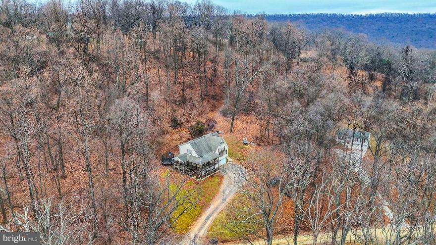 Welcome to 785 Maverick Trail! Nestled in the serene woods of the Sleepy Hollow subdivision, this 4-bedroom, 3-bathroom retreat offers the perfect blend of spacious living and natural beauty. Situated on a sprawling 1.19-acre lot near the top of the mountain, this home provides ultimate privacy and a peaceful escape from the everyday hustle and bustle. With 2,263 square feet of living space, a 2-car garage, and a large above-ground basement, this property offers plenty of room to live, store, and even expand by finishing the basement for additional square footage. From the moment you step inside, you’ll appreciate the thoughtful design and quality finishes, including hardwood floors that flow through the majority of the home, adding warmth and character. The main level features a spacious kitchen with an L-shaped island, abundant cabinet space, and expansive countertops that make meal prep effortless. A pantry area adds even more storage, while the thoughtful layout includes five entryways leading to two oversized decks that nearly wrap around the home. These decks are ideal for hosting gatherings, enjoying your morning coffee, or simply taking in the surrounding natural beauty. Wildlife enthusiasts will be delighted by frequent sightings of deer, birds, and other woodland creatures, offering a unique connection to nature. The main level also includes a well-sized bedroom with direct access to a full bathroom, making it a convenient option for guests or multi-generational living. Adjacent to the kitchen, the dining area and living room provide plenty of space for entertaining or relaxing. The upper level offers two large secondary bedrooms that share a spacious Jack-and-Jill bathroom, providing comfort and functionality for family members or visitors. The primary suite, however, is the true highlight. This expansive space includes two large closets, an ensuite bathroom, and a private balcony where you can unwind with a book, enjoy your morning coffee, or simply soak in the peaceful mountain atmosphere. The home’s exterior is equally charming, featuring color-changing lights on the front upper deck that add a touch of personality and fun. This property is more than a home—it’s a sanctuary. With its spacious design, thoughtful features, and unparalleled access to nature, it offers a unique opportunity to embrace a lifestyle of comfort and serenity. For extra piece of mind, this home also comes with a home warranty through First American Home Warranty! Don’t miss your chance to call this mountain retreat your own—schedule your private tour today!
