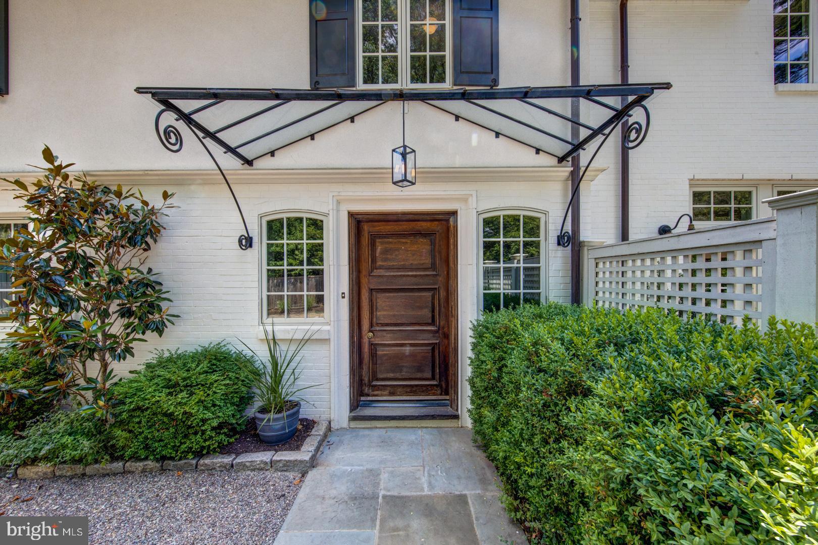 Beautifully set on one of Wyndmoor s most desirable streets is this stunning home with classic good looks. Perfectly set back and flanked on all sides by well maintained gardens and mature trees, this home affords you the comfort and privacy of a true country estate, and it s just a short drive to Chestnut Hill! Enter through the most charming original front door, into a spacious foyer with a gracefully curved staircase. The heart of this home is the spectacular chef s kitchen. What a dream- with a double Viking stove, expansive marble topped island, butler s pantry, marble sink and backsplashes, custom cabinetry, luxury fixtures, and integrated appliances. This open concept kitchen overlooks a great room with coffered ceilings and two walls of windows for bucolic views and natural light. The great room comfortably incorporates the family room and an oversized dining table large enough to entertain.For more formal entertaining, there is a separate dining room, formal sitting room, and a living room with a working fireplace, each with elegant details and walls of windows which open out to the covered patio. There are several patio seating areas for outdoor dining or lounging, and an abundance of spaces for socializing and relaxing.On the second level, we have 3 perfectly sized bedroom suites on one end of the center hall. Each attached bath is a little different in style, but equally finely appointed with beautiful tile work. On the other side of the hall, we have the master s wing, complete with two walk-in closets, and an exquisite and artfully tiled master bath with a gorgeous double slipper tub, 2 vanities, and a walk-in shower. The master bedroom has vaulted ceilings and french doors opening out to a sizable balcony. Additional features include a fully private guest suite, with an oversized living room, a serene bedroom, both with custom built-ins, and a full marble bath. The whole house audio system and sport court for tennis and basketball keeps everyone entertained! Off street parking and a 2 car garage. This house conveys with a subdividable lot that is now a side yard with a small grove of trees.There is no better place to call home!