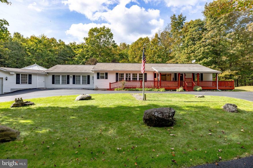 Tucked inside the quiet township of Middle Smithfield in East Stroudsburg sits a gorgeous home situated on one of the best lots in the neighborhood with over 11 acres! The curb appeal of the home is truly show-stopping with a long, tree-lined driveway, quaint covered front porch, fenced backyard oasis with a large deck looking out into the heavily wooded lot, and two additional storage sheds. This is a special property that boasts an open-concept floor plan with 4 bedrooms and 3 bathrooms, an all-season room, a walk-in pantry, and plenty of storage. The addition of an attached pool house with in-ground, concrete swimming pool, rounds out the many reasons that you will love this home and is truly a must-see for any buyer looking for a well-cared for home with a spectacular setting!