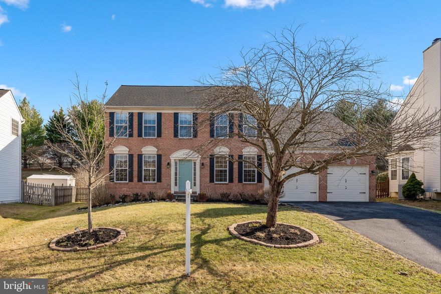Classic brick-front colonial in sought after Daniels Mill Overlook with 4 bedrooms, 2.5 bathrooms, 2 car garage, and a garden lovers backyard with three seasons of cutting blooms. Step into the 2-story foyer to find the warm hardwood floors throughout the main level. Adjoining the foyer is the private study and light-filled living room, leading to the beautifully trimmed dining room complete with crown molding and wainscoting. The updated kitchen features cream glazed cabinetry, corian counters, island, breakfast area, and leads to the sunken family room with gas fireplace. Just off the kitchen is the sunny morning room, the perfect spot for morning coffee and evening gatherings. The main level is completed with a convenient laundry room and powder room. The stunning primary suite features an oversized walk-in closet, cathedral ceilings, and a sitting area that would make the perfect dressing room, nursery, reading nook, or could be outfitted as a second walk-in closet. The generous primary bath offers dual sinks, soaking tub, separate shower, and water closet. The upper level offers three additional well-sized bedrooms and a full bath with dual sinks and tub shower. The lower level is ready for personalization, and features a workshop utility room, rough-in for a third full bathroom, and sliders to the walk out stairs. The fully fenced rear yard offers a large, easy-care composite deck, oversized shed, and is just about to come into season with carefully cultivated plantings that include early spring crocus, daffodils, and forsythia, summer lilies, irises, and hydrangea, and fall mums, just to name a few! The landscaping includes a sunny kitchen garden, mature pear, maple, redbud, and cherry trees, as well as a radiant crepe myrtle. Located in the Hollifield area of Ellicott City, this prime location offers easy commuter access to Fort Meade and NSA, DC, and Baltimore, as well as convenience to local shopping and dining. This is the move-in ready Ellicott City home you’ve been waiting for!