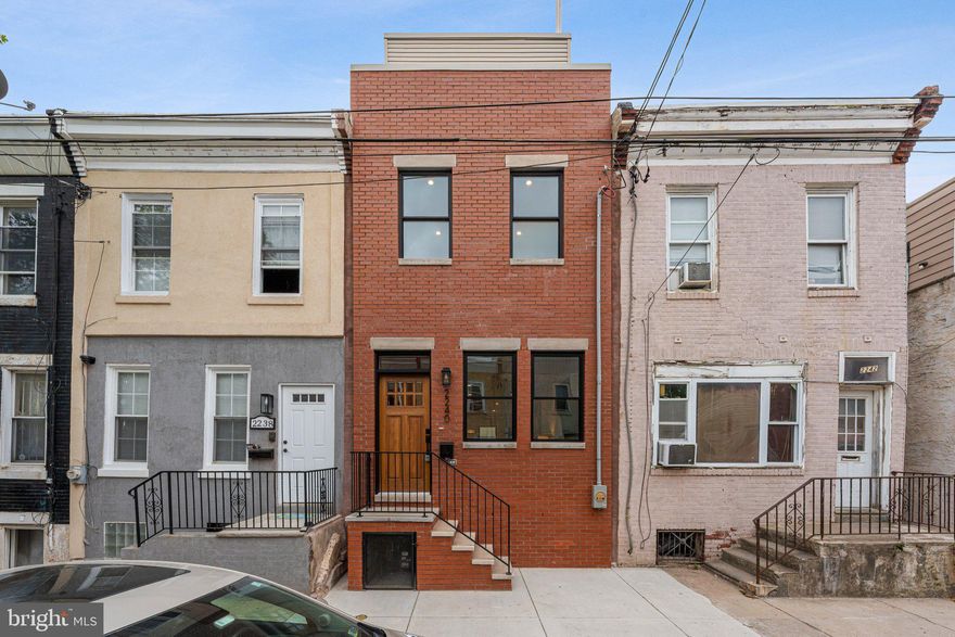 Welcome to 2240 Oakford Street, a stunning 2,100 sq. ft. custom-built home located in the heart of Point Breeze just two blocks from Washington Ave. This 3-bedroom, 3-bathroom new construction showcases exceptional craftsmanship and luxury living, with convenient access to Center City, Rittenhouse Square, and I-76. Step inside to an open-concept living area featuring engineered hardwood floors and a gourmet kitchen equipped with custom cabinetry, a spacious island, and stainless steel GE appliances. The private backyard is ideal for entertaining, offering artificial grass, and plenty of space for outdoor seating. The second floor features a large guest bedroom , a spacious walk-in laundry room with full sized side by side front load W/D included, a large hallway bathroom with a tub/shower and double vanity, and another generously sized bedroom at the end of the hall. The primary suite includes a luxurious bedroom, a massive walk-through closet with custom built-in shelving, and a spa-inspired bathroom with a double vanity and a large glass-enclosed shower. Just outside the primary bedroom, enjoy access to a front balcony or head up to the expansive rooftop deck, offering breathtaking panoramic views of the city skyline, stadiums, and bridges. The finished basement provides a full bathroom and flexible space for an optional fourth bedroom, office, or entertainment area. Additional highlights include a 10-year tax abatement and a 1-year builder’s warranty. Don’t miss this rare opportunity to own a luxury home in the vibrant Point Breeze neighborhood.