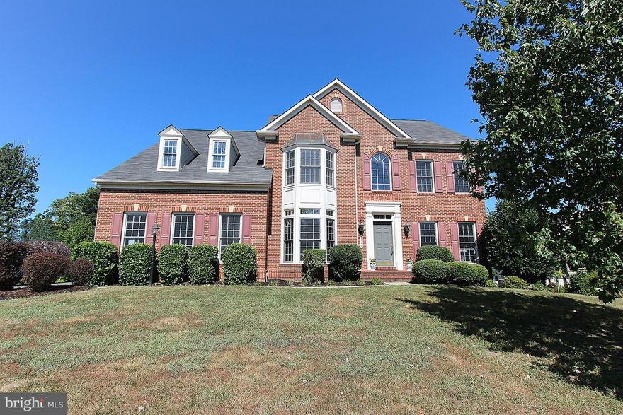 Huge Colonial w/6 bedrooms,5 full baths! Main LVL features HW flrs, 2 story stone gas FP, sep din rm, & bedroom.Kitchen has large island w/granite, double wall oven, gas cooktop, SS appliances. UL has 4 beds, all w/ walk-in closets, & spacious master suite. Finished W/O LL has legal bedroom, full bath, storage, and much natural light. 2 car garage, NEW W/D, NEW Fiberon 42 ft deck finished SEP2015!