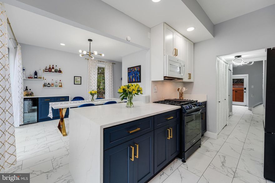 Welcome to this stunning and renovated waterfront home.  It was chosen to be on the prestigious Reston OPEN HOUSE CANCELED. Home Tour in 2023. The classic mid-century modern meets elevated modern to create a one-of-a -kind lakeside escape. It’s all about the vast views whether sitting on one of two expansive decks or looking out one of the floor-to-ceiling windows on all three levels. This home was made to enjoy and entertain all year long! BBQ when the weather permits or cozy up to a fire with winter scenes of gorgeous Lake Anne. Launch a boat, canoe, or paddleboat from your private dock or walk to The Lake Anne Plaza offering entertainment for all. From the iconic Used Book Store to gourmet dining with jazz at Lake Anne Wine Bar and Coffee House.  Enjoy the fun community events such as the Cardboard Boat Regatta, concerts, and holiday celebrations. 
The house was designed by renowned architect, Chloethiel Woodard Smith, FAIA. It is one of the largest models in the cluster and lives like a single family.. Remodeled and updated in 2023 which includes new flooring on the first level, original hardwoods sanded and stained on the 2nd and 3rd levels. The fresh new open kitchen boasts nautical navy base cabinets and upper crisp white cabinets. The appliances include a five-burner gas range with air fryer function, Samsung dishwasher, Samsung Twin Cool refrigerator with interior beverage center. The waterfall quartz countertops make a luxurious statement. Grab a quick snack at the breakfast bar while watching the nature that abounds on and around Lake Anne. The kitchen was opened to flow into the dining room complete with cocktail bar that match the kitchen nautical décor with Schmecke beverage refrigerator.  Both the kitchen and dining room have sliding doors that lead to the over sized deck. The living room has a cozy gas fireplace as well as a sunroom.  The house has one of the few coveted sunrooms and it’s a great place to enjoy the lake views on a rainy or snowy day.  It can feel like your own igloo when the snow covers the glass ceiling!
Let’s climb the modern updated staircase complete with black treads and black stainless-steel cable and railing to the second floor with three ample size bedrooms and two full baths. The back bedroom with lake views is being used as an office, the second bedroom an exercise room, and the third bedroom in the front of the house as a guest room.  Outside the first bedroom is a full bath and large closet that can be converted to a full ensuite. These rooms offer very flexible space. 
The 3rd level the owner transformed into a primary suite retreat that she loves! It is complete with an electric fireplace, fully renovated bath, shower featuring two shower heads, double vanity with a private toilet closet.  Step out onto the upper private Trex deck to watch the stars and experience the serene atmosphere in the tree. 
The inviting and private courtyard entrance is so welcoming. It has a large custom built-in   storage cabinet. This home has a carport with another storage closet. The back yard offers you own private dock. 
 Inside the foyer, can you find the hidden closet?