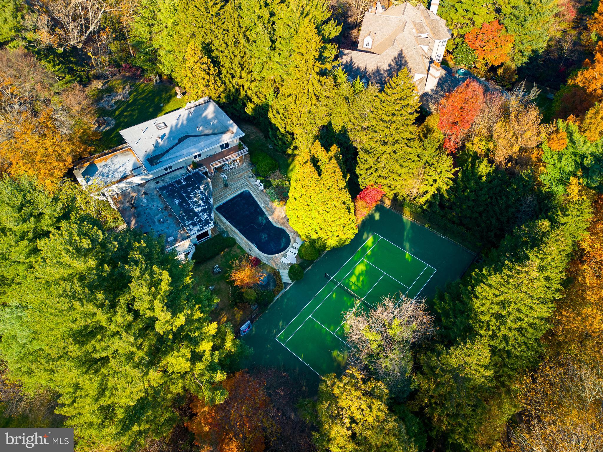 Property is back on the market after Buyer's financial situation changed. Discover an exceptional Main Line residence unlike any other in this stunning indoor-outdoor 4BD/3.5BA midcentury showplace featuring a tennis court, pool and 1.18 acres of park-like grounds by a well-known landscape architect. Inside the 5,276SF residence, enjoy a sprawling layout filled with walls of windows, hardwood floors and three fireplaces. The sunken great room leads to a formal dining room, a gourmet eat-in kitchen and a sun-splashed family room. The dramatic double-height library is joined by a separate private study. Above, the luxurious owner's suite boasts a spa bath, attached gym/nursery, sauna and two balconies. Three secondary bedrooms, two baths, a powder room and a full-height lower level complete the layout. Outside, enjoy a large wood deck with BBQ surrounding the sparkling pool or perfect your serve on the tennis court that was resurfaced about a year ago. A gated drive, motor court and three-car garage add plenty of parking to this secluded sanctuary close to the best Main Line and Center City amenities.