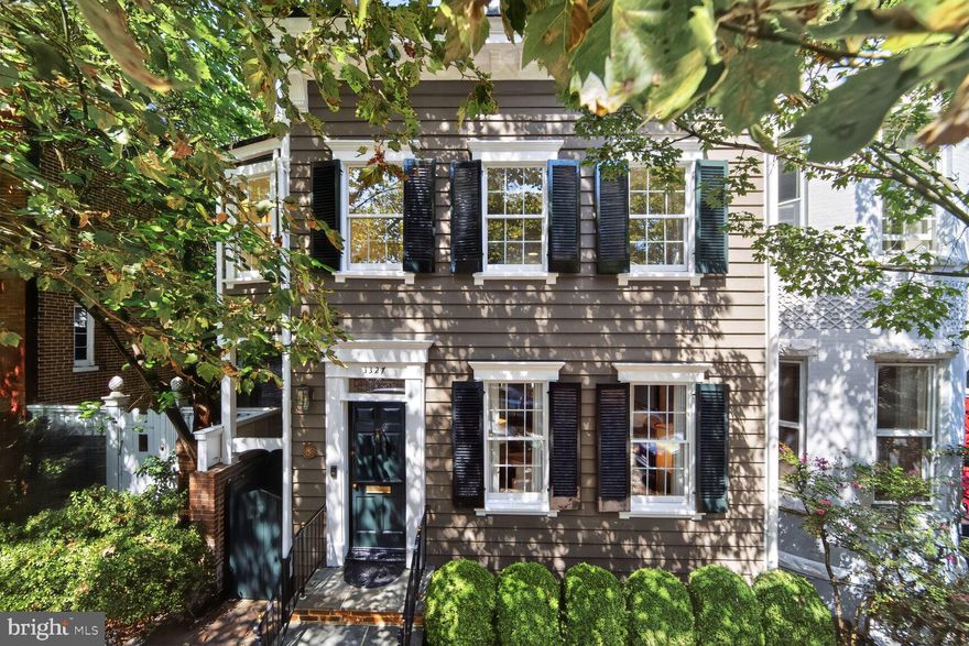 Stunning light-filled Georgetown Townhouse with garden and parking on Cobblestone Street.

This elegant, semi-detached townhouse, originally built in 1867, graces a charming one-way cobblestone street on one of Georgetown’s most desirable blocks. This historic property, once home to the famed World War II spy Betty Pack, offers four bedrooms, four full bathrooms plus a half bath, a large professionally landscaped garden, private driveway and a large two car garage. It was included on the 2016 Georgetown House Tour.

On the main level, a welcoming foyer flows seamlessly into a spacious formal double living room with custom built-ins and two fireplaces perfect for entertaining. The room leads directly into a large light-filled dining room, boasting a ten foot ceiling, skylight, and serene garden views through large glass windows. The dining room opens into a light-filled family room with three skylights, historic Oriental carved wooden doors, a powder room, and six-foot glass windows and a door wrapping around the back showcasing the flagstone terrace and the expansive, exquisite garden with outdoor seating areas. A newly renovated kitchen boasts new cabinets, new countertops with marble houndstooth backsplashes, a Sub Zero refrigerator, Wolf range, and Bosch dishwasher plus the coveted convenience of a separate front entrance. 

On the second floor, the luxurious primary suite encompasses a comfortable sitting area and an entire wall of new closets with automatic lighting. The beautifully renovated primary bathroom features new heated hexagon marble floors, a free standing tub, and a glass-enclosed shower with Waterworks fixtures and a double vanity with Carrera marble counters. The guest bedroom is bright, bathed with fantastic light from windows on three sides and a newly renovated en suite bathroom.

The third floor features a large bedroom suite, ample storage, and an en suite bath. It has windows on two sides, with three large windows across the back providing a stunning view overlooking the garden and the surrounding trees. It is perfect for a guest suite and an office.

The lower level offers a bedroom, sitting area, two large closets, newly updated full bathroom, and a laundry room with washer and dryer. The unfinished portion of the basement provides a tremendous amount of storage, including eight built-in closets and four additional drawer-shelving units, with an exit directly to the patio, garden, and garage.

This elegant Georgetown townhouse masterfully combines historic character with modern luxury in one of Washington DC's most prestigious neighborhoods.