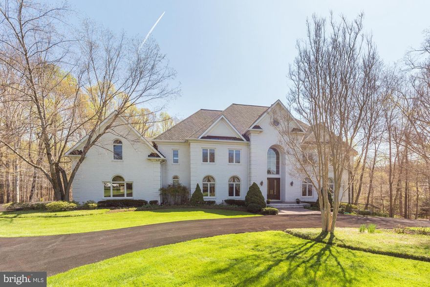 Special amenities include high ceilings, custom moldings, oversized windows with arched transoms and numerous custom built-ins. Beautifully renovated with SS appliances, huge island, granites & ceramic tiled backsplash open to FR. 5BR's & 4FBA's up + multi-purpose room, W/o LL w/ BR, BA, Rec Room, wet bar &sunroom. Gated entry, 4 car garage, flat lot, terraces, circular driveway & more...