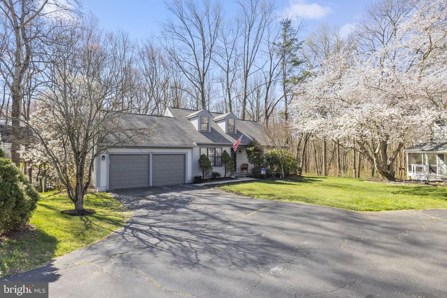 Offer in Hand - all offers due by 8pm Monday 3/25.  Fantastic home located in a private wooded cul-de-sac in the sought after community of Montclair.  This beautiful home features a rare main level primary bedroom with sitting area and 2 large bedrooms on the second level with full bath.   The open kitchen features tile floors, painted cabinetry,  prep island with granite top, a gorgeous backsplash, and a  fantastic dining area.  Sliding glass doors lead from the kitchen to a fabulous private  12'x12' deck with amazing views of woodlands and a stream  - the  perfect space to relax with a cup of coffee or entertain family and friends. The huge lower level includes a  large walkout rec room,  full bathroom, sliding glass doors to a patio and the backyard, a large storage room and another unfinished space perfect for an office or craft room. There are so many fine details throughout including hardwood floors in the living room, built in book shelfs and crown moldings. Freshly painted and updated with newer flooring in the kitchen and brand new carpet in owner's and rec room, new garage doors in 2023 , new siding, gutters and deck in 2020,  newer 80-gallon water tank, fully fenced rear yard.  Tons of storage and space for your workshop in the oversized 2-car garage with brand new garage doors and the huge storage space in the lower level.  Gardeners will enjoy the azaleas, rhodadendrons and hydrangeas. The Montclair community has so many amazing amenities including 3 beaches, miles of walking trails, a sanctuary for bird watchers, dog parks, playgrounds, and access to the Montclair Country Club and golf course.  This unique community even has its own shopping center and elementary school.  Commuters appreciate this fantastic location just minutes to I95 and convenient to the Rippon Landing VRE, Quantico and Fort Belvoir.   Minutes to fantastic restaurants and shopping.  Don't miss out on the chance to own on one of the prettiest streets in Montclair!