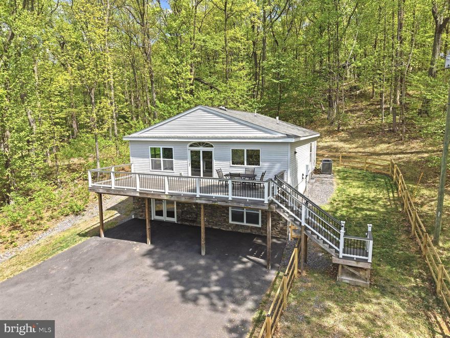 Overlooking the beautiful Shenandoah Valley, this home offers the privacy, elevation, and peaceful setting that make mountain living so desirable, with easy access to Front Royal and points east via I-66, just a few minutes away. Situated on just over 2 acres, this 3-bedroom, 3-bathroom home features an open floor plan with a vaulted beamed ceiling and stone gas fireplace. The gourmet kitchen offers custom cabinetry, granite countertops, stainless steel appliances, and a farmhouse sink with a reverse osmosis water filtration system that conveys. The spacious primary suite includes a walk-in closet with convenient pass-through access to the laundry room as well as a radiant heating system in the bathroom floor for comfort in cooler months. Step outside to an expansive and easily maintained Trex deck and covered patio overlooking breathtaking mountain and valley views. The walk-out lower level includes a third bedroom, full bath, recreation room, and a bonus room ideal for a home office, gym, or guest space, plus generous storage. A whole-house water purification system, added in 2022 and currently serviced by Culligan, also conveys. Finally, this home offers the rare convenience of a fully paved and HOA-approved driveway for reliable access throughout the year.
Community amenities include a private lake, pavilion, playground, basketball and tennis courts, as well as snow removal in the winter and road maintenance throughout the year. Convenient to Front Royal, Shenandoah National Park, Skyline Drive, the Shenandoah River, wineries, hiking, and dining, with a great commuter location to Northern Virginia. A perfect blend of mountain views, modern comfort, and outdoor recreation. Seller is offering a  'Winter Readiness' credit to ensure a seamless transition to mountain living. Call for more information.  Enjoy the video tour and floor plan. All sizes are approximate.