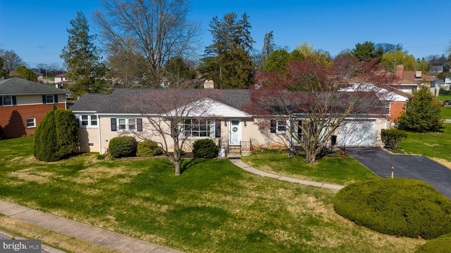 Situated on a nice corner lot surrounded my mature landscaping. Featuring a fenced in backyard for privacy. Enjoy the ease of one-floor living with a bright, open layout and hardwood flooring throughout. Just off the foyer, the spacious living room features a bay window and a cozy wood-burning fireplace—perfect for relaxing or entertaining. The kitchen includes quartz countertops and maple cabinetry and flows seamlessly into a charming breakfast area with custom built-in bookshelves, as well as a formal dining room. A breezeway adds both character and convenience. The primary suite is a true retreat, complete with a sitting area and an en-suite bath featuring a Jacuzzi soaking tub. An additional bedroom, full bath, and optional laundry hookups complete the main level. The finished lower level provides a versatile rec room for added living or entertaining space, along with a utility room equipped with a washer, dryer, and utility sink. Ideally located just minutes from shopping, dining, and everyday amenities, with easy access to I-83 and Route 30 for a convenient commute.