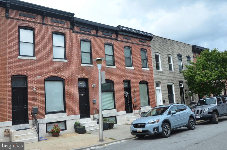 Brick-Front 3 bd, 2 bth home w/ off-street parking! Property features gourmet kitchen w/ granite, SS app & custom mocha cabinetry; hardwood flooring & trim package - includes feature wall in dining rm, recessed feature over island & crown moldings throughout. Other features include custom vanities, bonus room, deck off kitchen, designer light fixtures & much more. Close to Patterson Park!