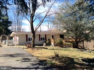 SOLD BEFORE PROCESSED!! What a perfect setting for this lovely 3 bedroom, 2.5 bath rancher nestled near the woods! Cozy living rm has large picture window & brick fireplace. Roomy family rm w/woodstove has a 4th bedrm option. Large wrap around deck leads to in-grnd pool in back. Oversized carport has your own electric generator! 2 driveways for extra parking! Open House, May 3, 1-3 PM!