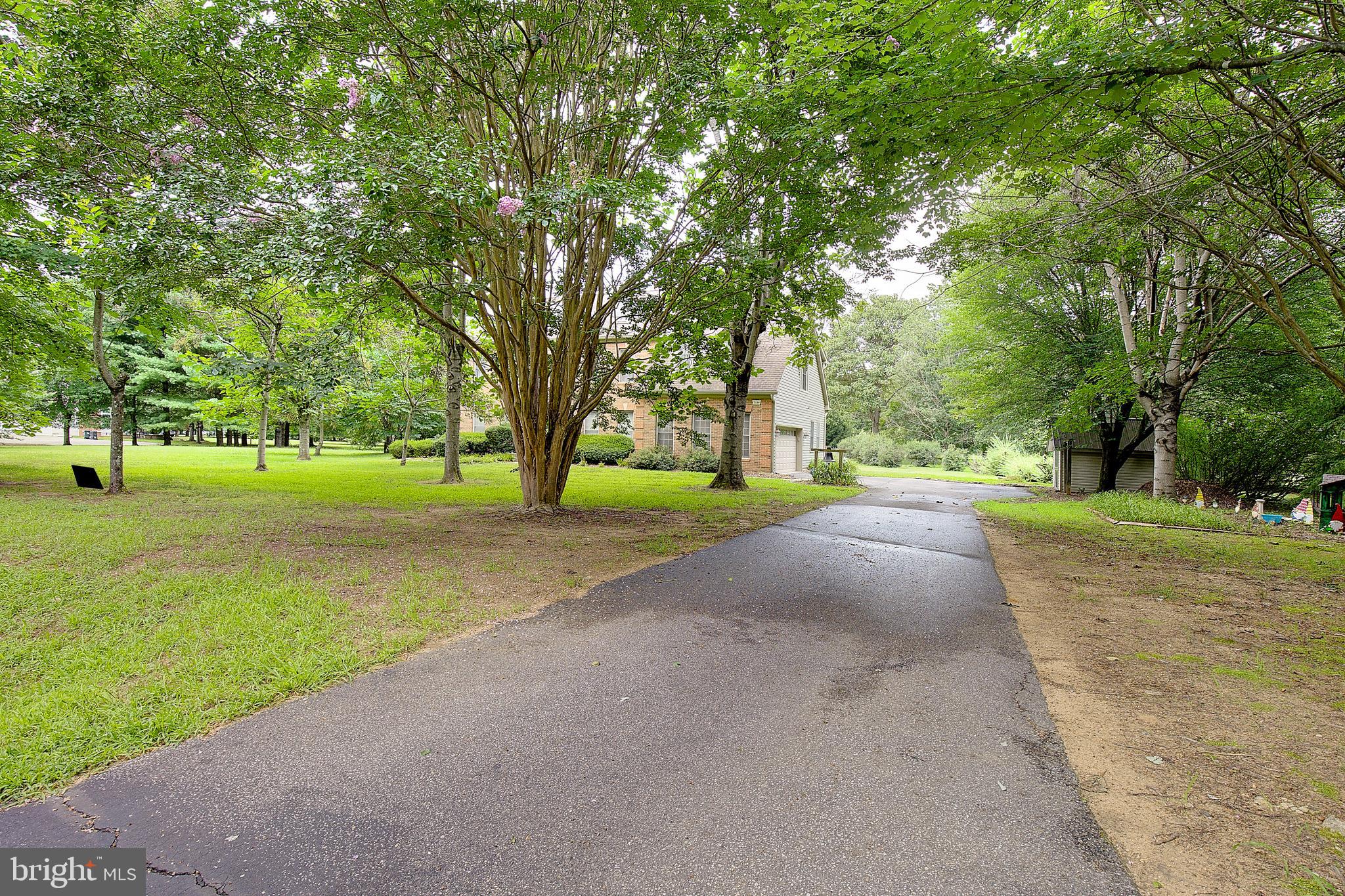 Welcome to your private retreat in the heart of Gambrills. Situated on a pristine, flat 2-acre lot in the sought-after Patuxent Run neighborhood, this stunning estate offers over 5,000 square feet of beautifully maintained and thoughtfully updated living space. Nestled in a no-thru street enclave off Rt. 450, peace, privacy, and exclusivity come standard—while still keeping you just minutes from major routes, shopping, and the best of the DC-Baltimore-Annapolis corridor.
From the moment you arrive, the stately curb appeal, side-load two-car garage, and expansive lot set the tone. Inside, the grand two-story foyer welcomes you with elegance, flowing seamlessly into a soaring two-story family room anchored by a statement fireplace wall. The open-concept kitchen is the heart of the home, featuring 42” maple cabinetry, a spacious island, solid surface countertops, stainless steel appliances, and easy access to a generous laundry room and garage.
Formal spaces shine with custom millwork—wide crown molding, wainscoting, and thoughtful architectural details grace the dining room and a flexible front room ideal for an office or sitting room.
Upstairs, retreat to the luxurious primary suite complete with a large walk-in closet, spa-style bath with soaking tub, separate shower, dual vanities, and a sitting room. Three additional oversized bedrooms and a full hall bath complete the upper level.
Downstairs, a fully finished lower-level apartment offers the ultimate in versatility and value—perfect for multi-generational living, long-term guests, or rental income. With its own private entrance, full kitchen, spacious bedroom, full bath, living area, and bonus room currently used as a walk-in closet, the possibilities are endless.
Located in the highly desirable Crofton school district, this is a rare opportunity to own a truly exceptional home that combines grand scale, flexible living, and unmatched convenience.
Welcome home to Patuxent Run—where luxury lives quietly.
