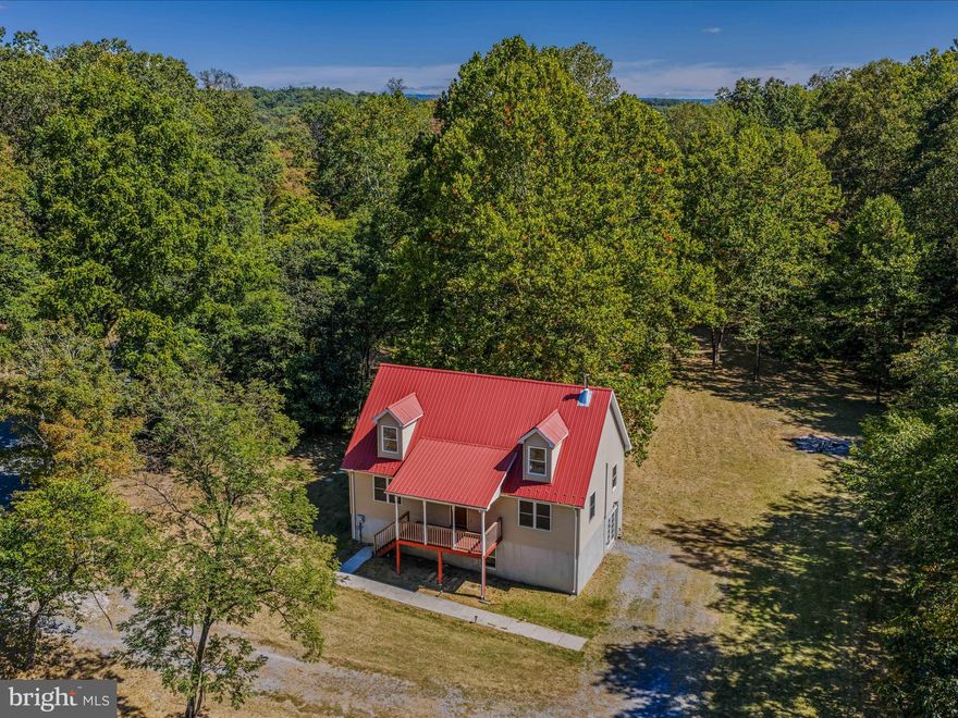 Welcome to 251 Rock Gap Rd! Sitting on 14+ acres with a stream (Rock Gap Run) running through it, this little slice of heaven offers 3 bedrooms, 2.5 bathrooms, an office, a loft, and a huge open living/dining/kitchen area with vaulted ceiling.  A cozy wood stove will keep you warm on those cool autumn nights or enjoy a campfire outside instead. Relax on your front porch, breathe in the fresh air, and take in the great view and beauty of nature all around. The changing fall colors will be a sight to behold.  The walkout level basement offers even more space for storage or a workshop area. Enjoy exploring, hiking, and hunting on this wonderful piece of property. If you prefer a day out, more entertainment can be found 3.3 miles south at Cacapon Resort State Park where you can enjoy swimming, biking, fishing, golf, horseback riding, a nature center and more! Or head back north to the quaint town of Berkeley Springs where hot springs, spas, restaurants, shopping, and other amenities await you. Make this your year-round home, vacation home, or potentially an Airbnb! (Buyer to verify possible uses of the property) Due to the stream running through the property, a portion of it is in the flood zone but the house is not. Approx. 25 minutes to I-70 and 2 hours from D.C. and Baltimore. Don't miss out on this one! Schedule your tour today!