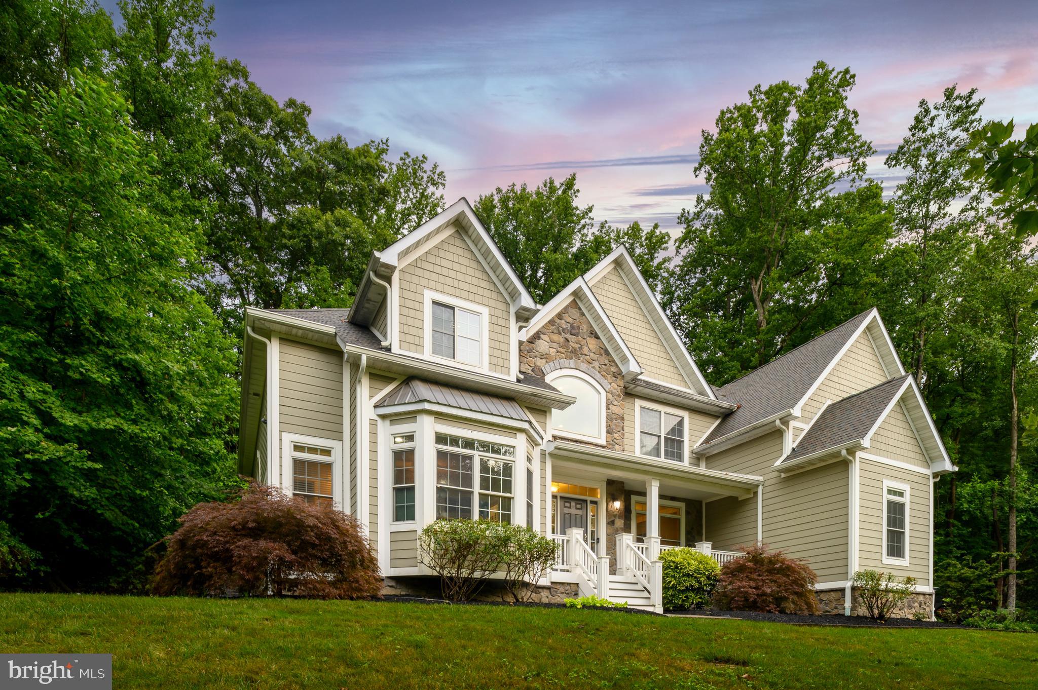 Gracious Colonial Living with Refined Interiors & Resort-Style Backyard --
Architect-designed and custom-built in 2013, this distinguished Colonial home offers timeless architecture paired with thoughtful, high-end finishes throughout. A covered front porch with composite decking provides a welcoming entry and a charming spot to relax—even in the rain. Inside, a grand foyer with sweeping staircase opens to expansive interiors featuring hardwood flooring on both the main and upper levels. The chef’s kitchen is a true centerpiece, outfitted with a gas cooktop, double oven, stainless steel appliances, white cabinetry, and a wraparound breakfast bar perfect for gathering and entertaining. The formal dining room includes a convenient wet bar, while the soaring two-story family room showcases floor-to-ceiling brickwork surrounding a gas fireplace and beautiful Palladian windows. The main-level office is ideal for today’s professional, with entry from both the foyer and a separate private entrance. Upstairs, four well-appointed bedrooms include a luxurious primary suite with a spa-like ensuite featuring a separate shower and Pure Air Tub. The finished lower level offers a recreation room with luxury vinyl plank flooring, a full bathroom, an additional bedroom, and an exercise room—plus French doors leading up to the backyard. Outdoor living is just as exceptional, with a heated in-ground pool featuring an auto cover, a paver patio, firepit, and a stone retaining wall. Set on 2 acres, the property includes a beautifully cleared area atop the hill that borders Homestead Gardens—ideal for play, peaceful views, or future landscaping. An additional ¼–½ acre clearing is perfect for a garden or other creative use. With Hardy Plank siding, a tankless water heater, dual-zone HVAC with propane backup, and a 20kW standby generator with transfer switch and propane hookup ready for installation, this home is built for comfort, style, and enduring value.